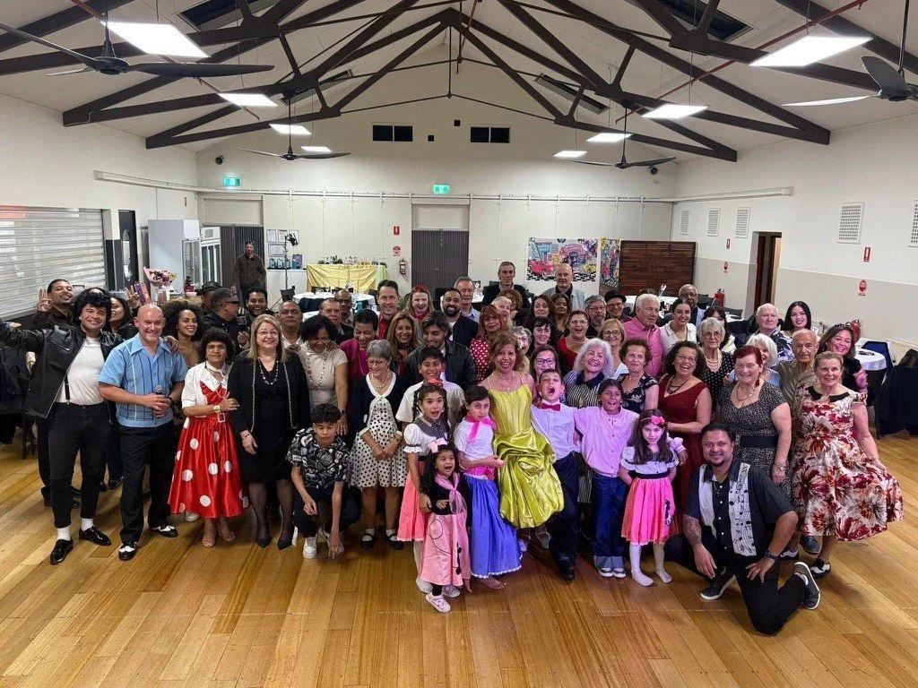 Large group of people dressed in 50's attire in ANZAC Hall for birthday party at Urban Camp