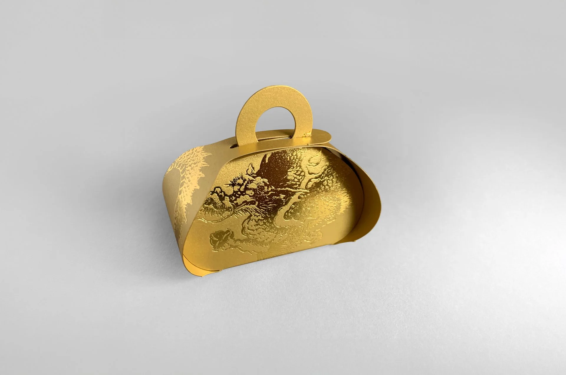 Created entirely from one sheet of paper, the box is easily constructed and held in place with loops. The design employs a 300gsm metallic gold paper and the dragon is emblazoned with a gold foil.