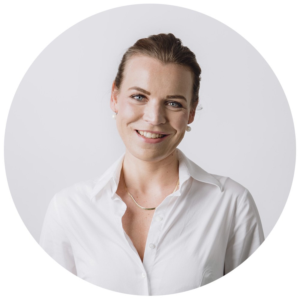 Friendly Headshot of a person in a white shirt against a plain background