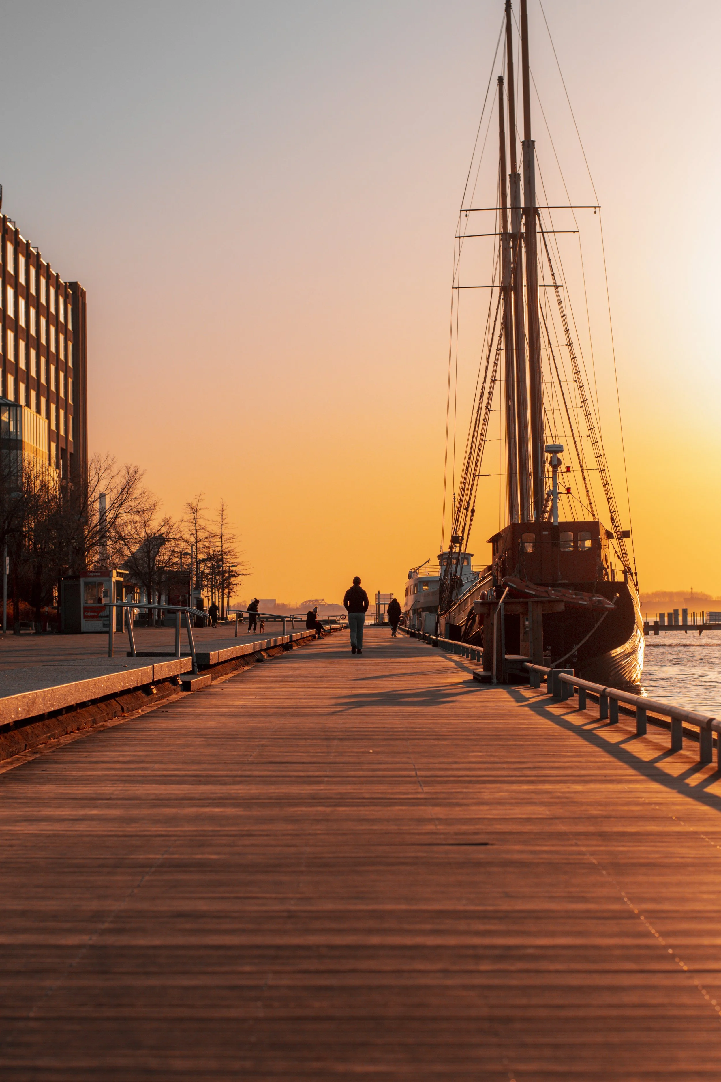 The sun rises over the boardwalk by the downtown Toronto Waterfront. March 22, 2021. (Kaj Larsen Photo)