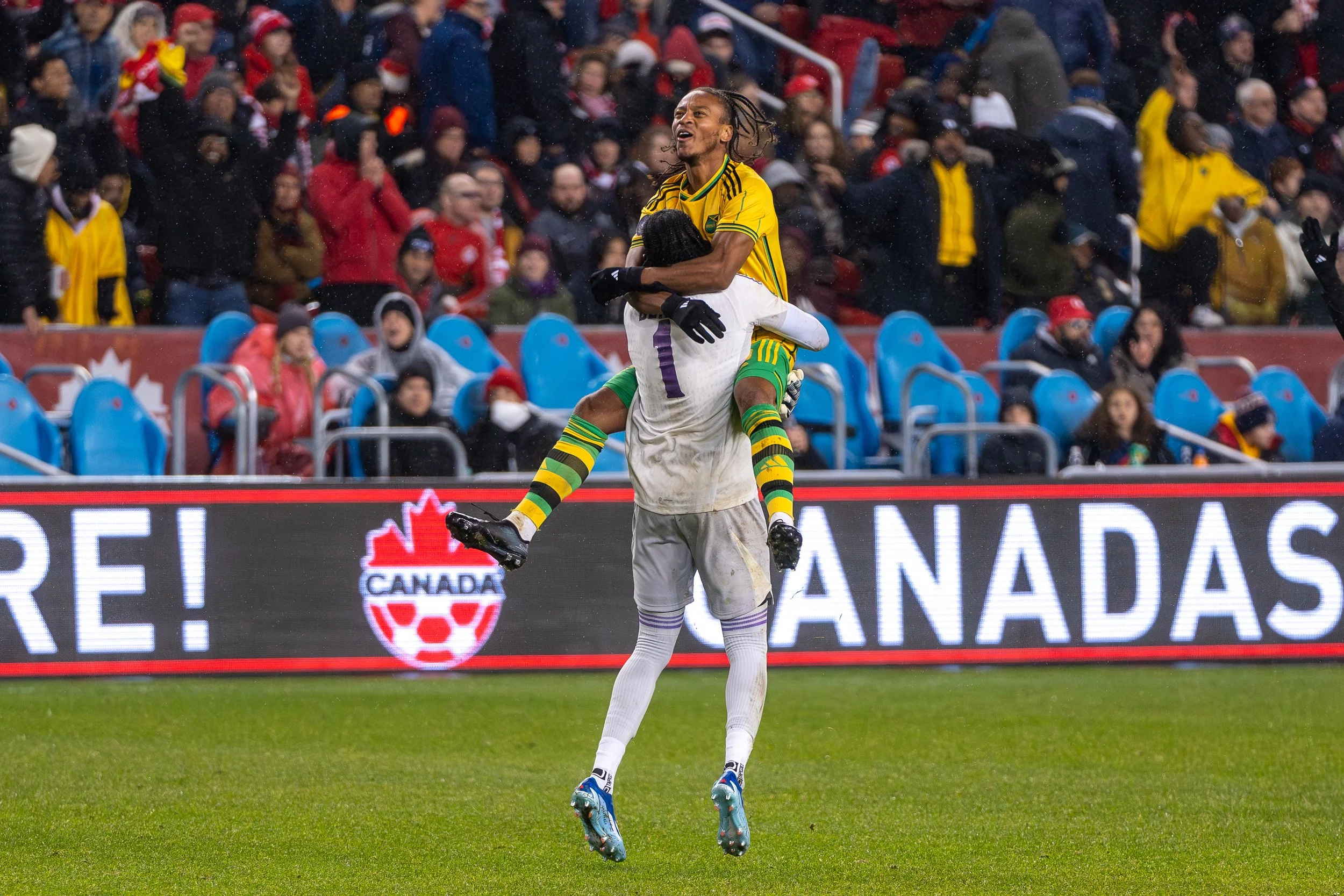 Jamaican forward Bobby Cordova-Reid jumps into the arms of goal keeper Andre Blake following their 3-2 victory over Canada in the Nations League quarterfinals to qualify for the Copa America. November 21, 2023. (Kaj Larsen Photo for Canadian Premier