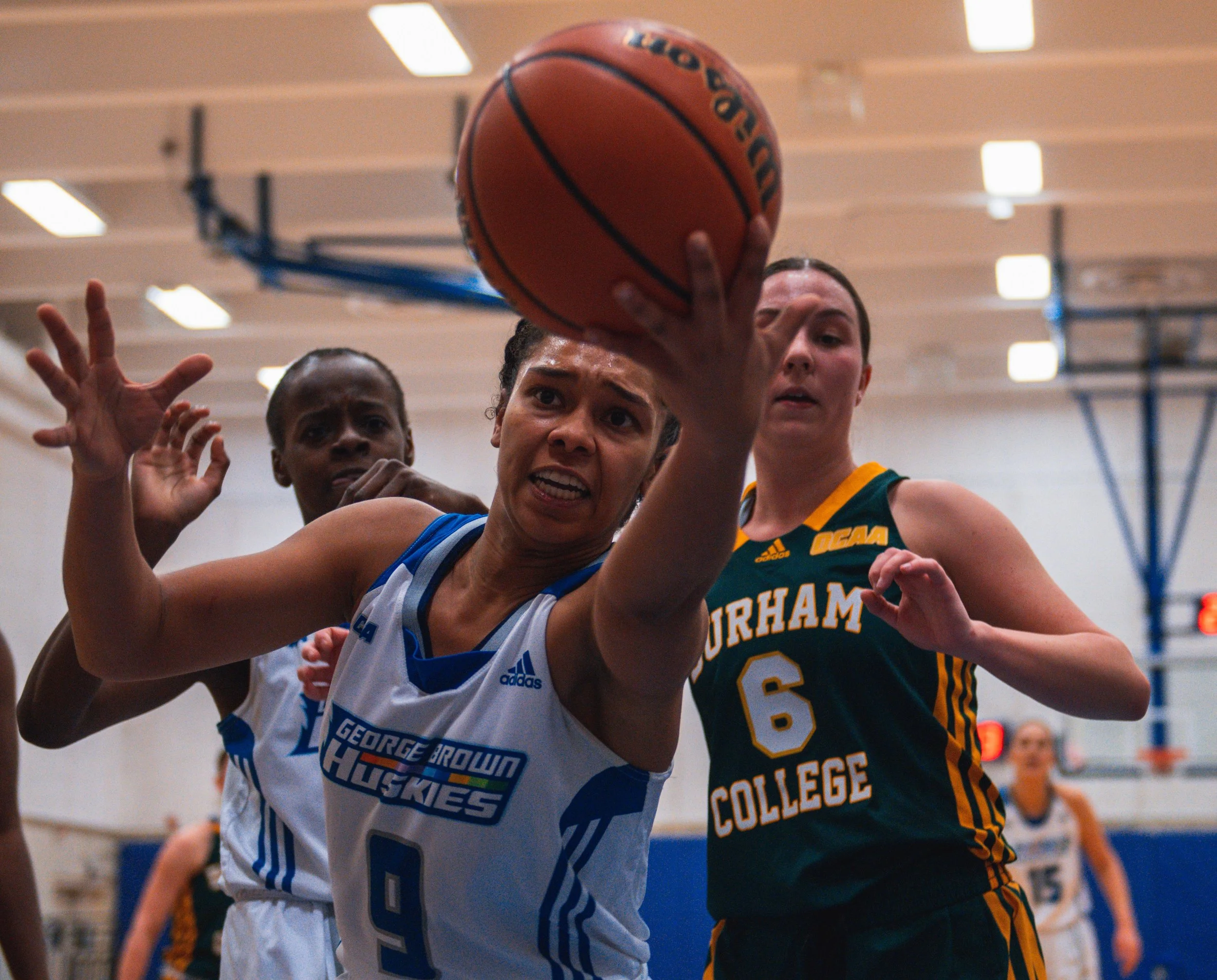 George Brown Huskie Meeko Thomas keeps a ball inbounds along the baseline vs. the Durham College Lords. February 25, 2022. (Kaj Larsen photo for George Brown College)