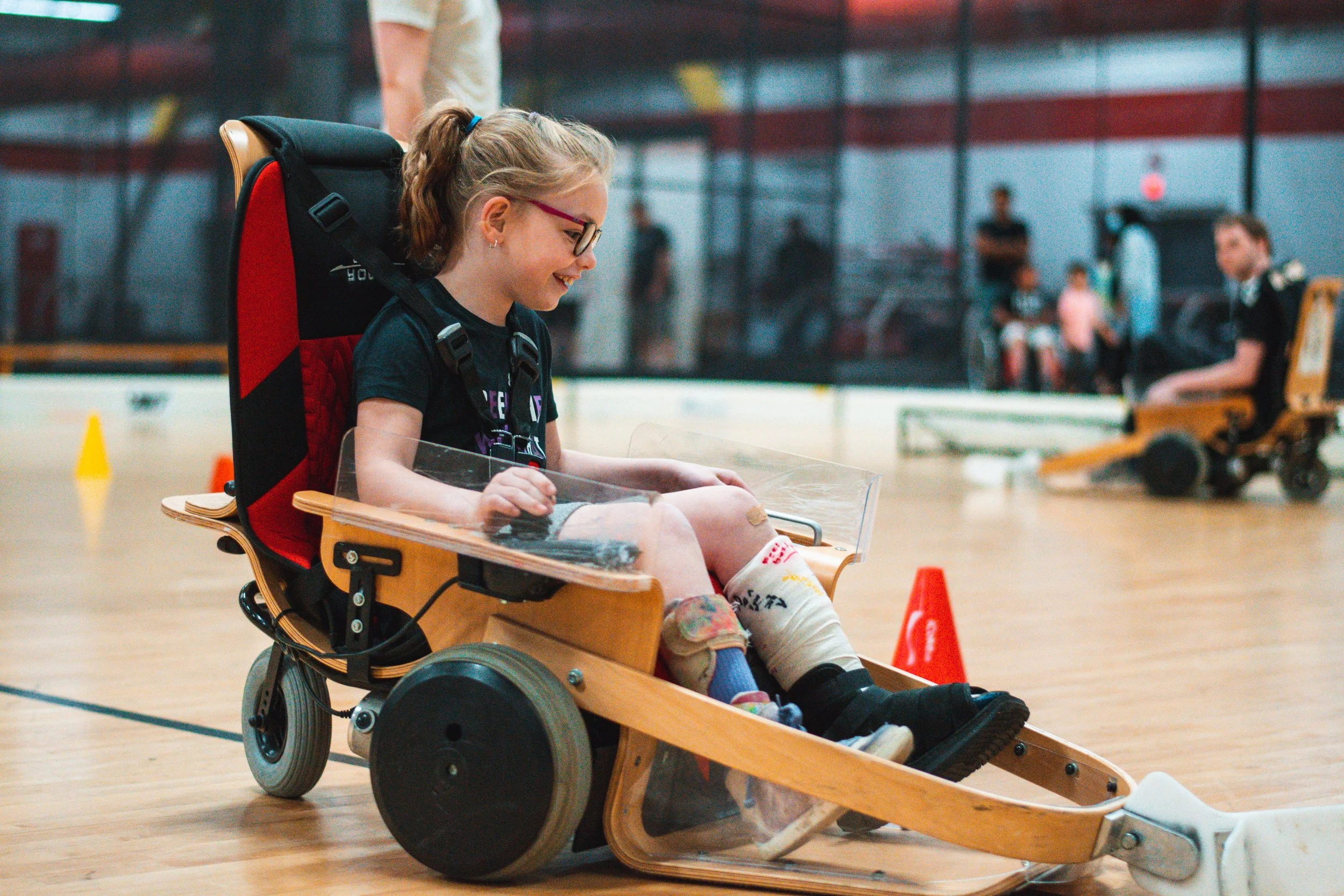 Madi plays VOLT Hockey at Variety Village. VOLT Hockey is an accessible version of hockey with motorized vehicles controlled by a joystick. May 28, 2022. (Kaj Larsen photo for Variety Ontario)