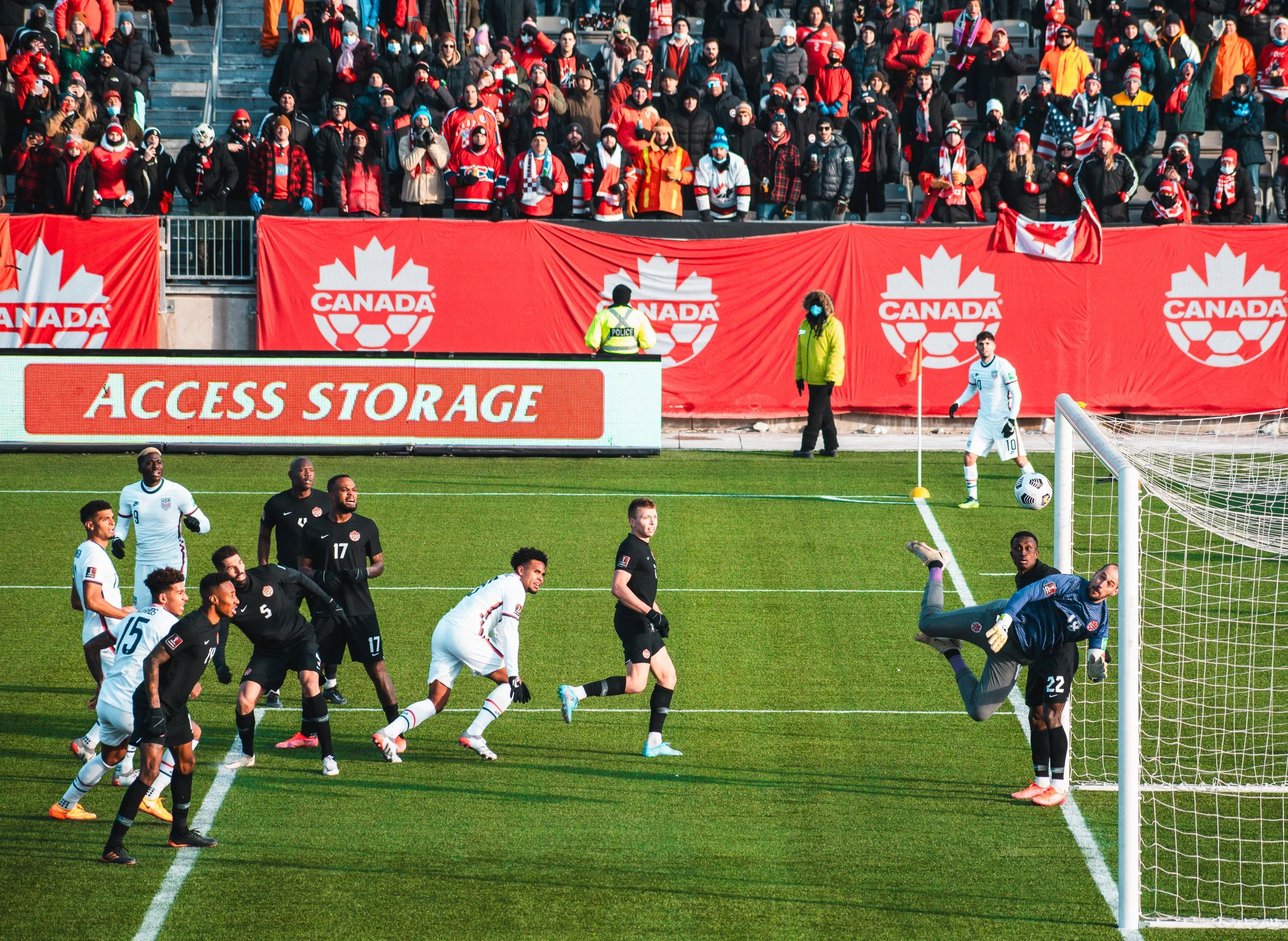 USMNT and CANMNT players observe as Canada keeper Milan Borjan makes a diving save during Canada's 2-0 victory over the United States in a World Cup qualifying match at Tim Hortons Field in Hamilton, Ontario. January 30, 2022. (Kaj Larsen Photo)