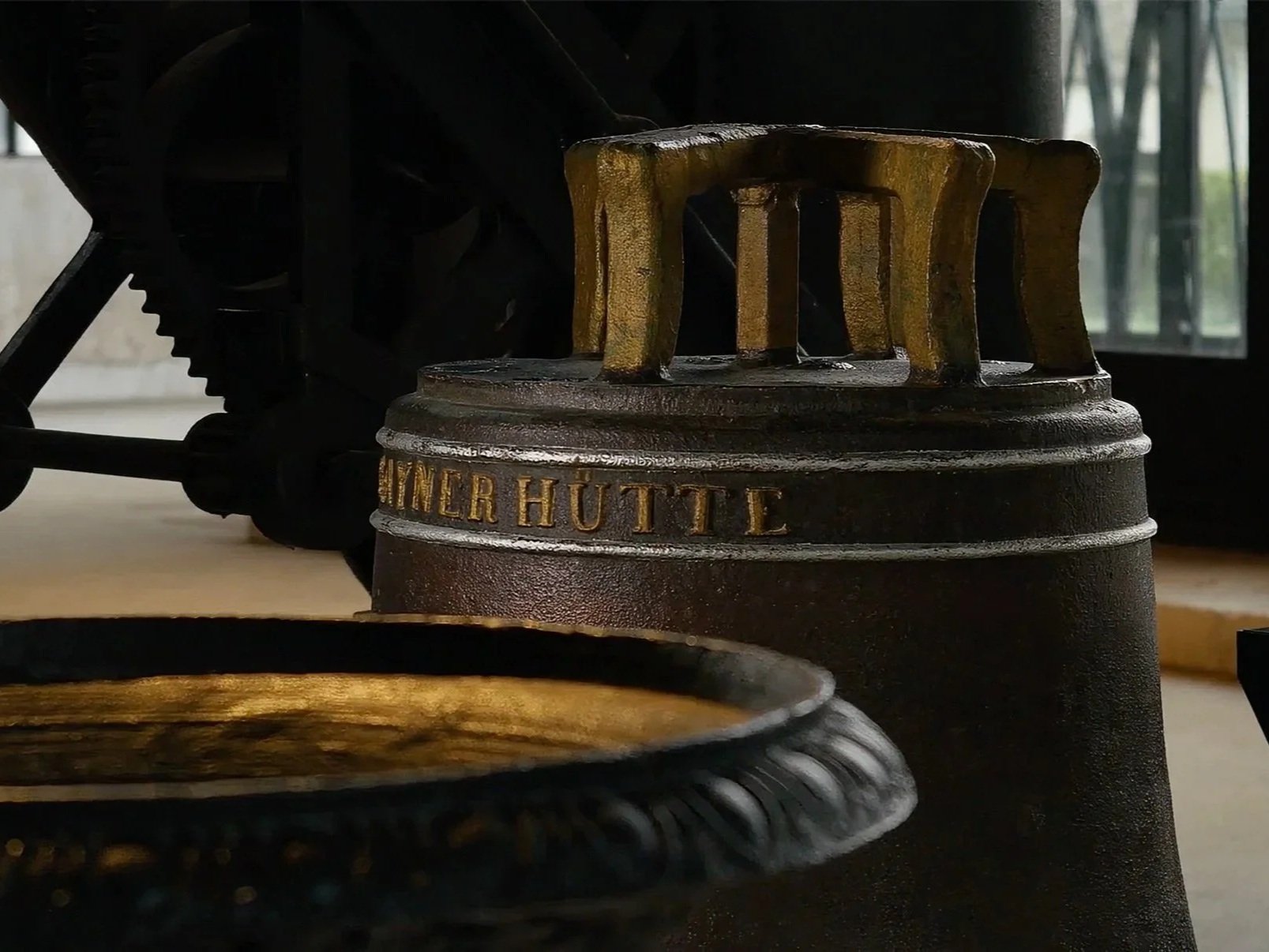 Altmetallrost mit der Aufschrift »Imbacher Hütte« in einem industrial Design. Im Hintergrund sind Fenster zu sehen.