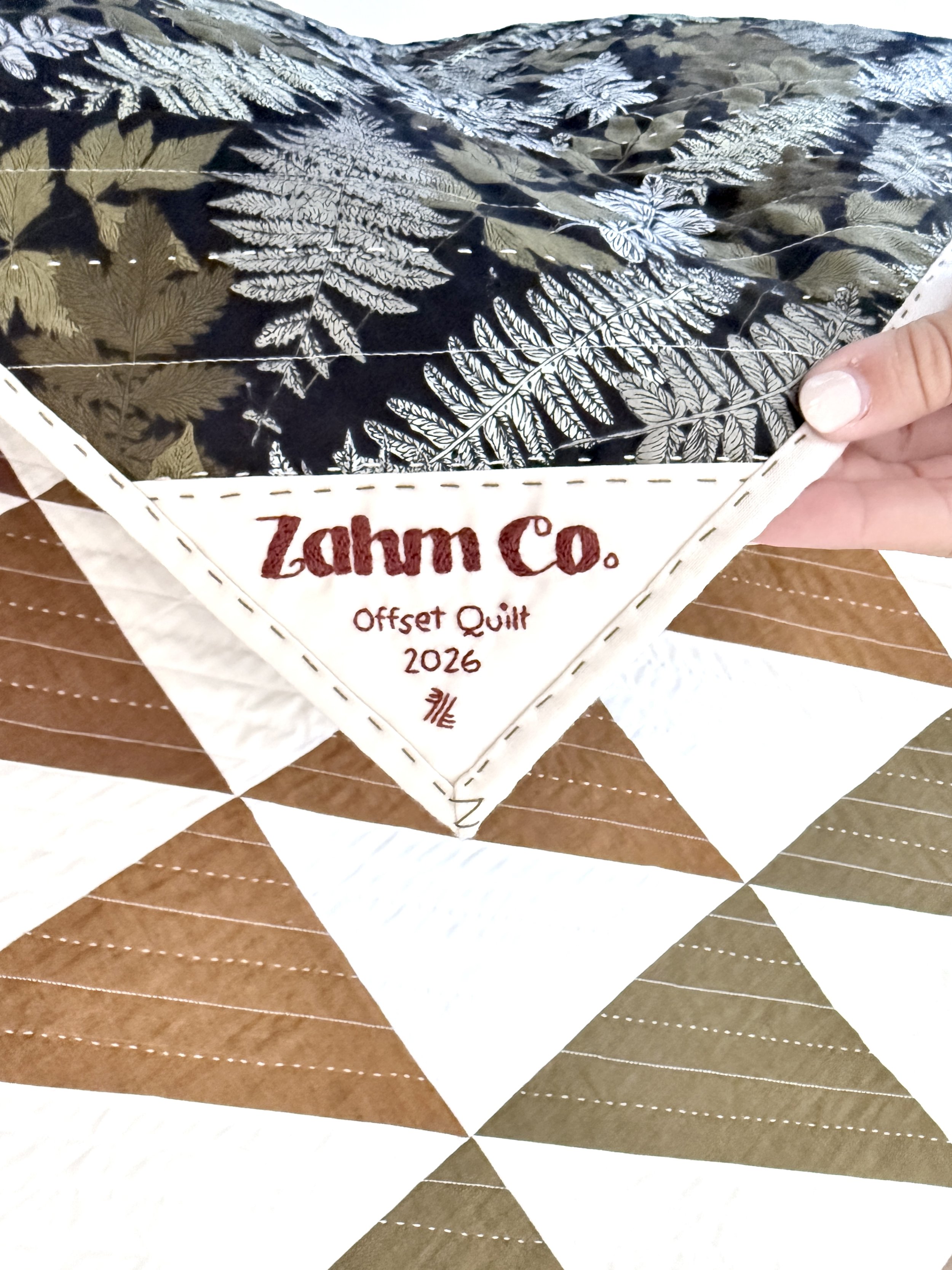 Offset quilt with hand embroidered label
