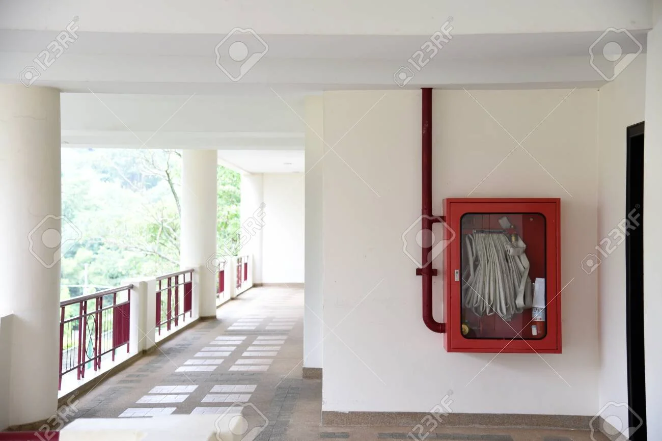 108947550-fire-extinguisher-and-fire-hose-reel-in-hotel-corridor-fire-hoses-rack-for-use-.jpg