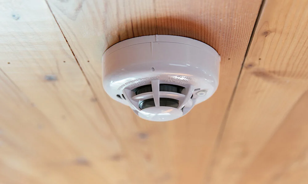 smoke-detector-wood-ceiling-closeup.jpg