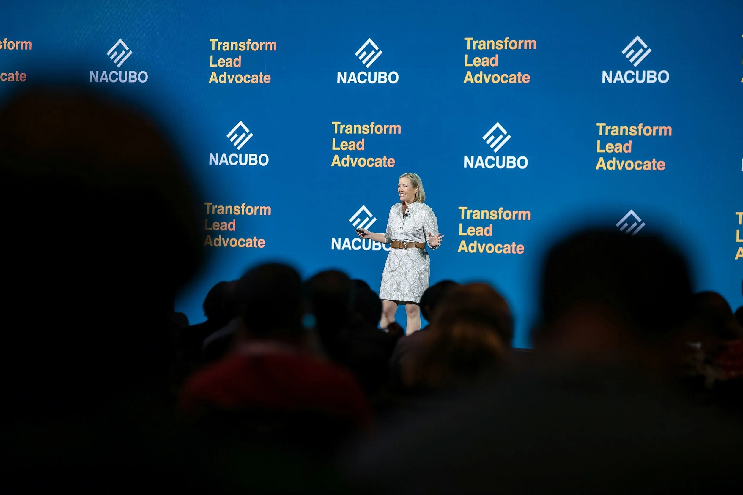 Melissa Marshall presenting on stage at NACUBA speaking about presentation training and coaching for scientists and engineers