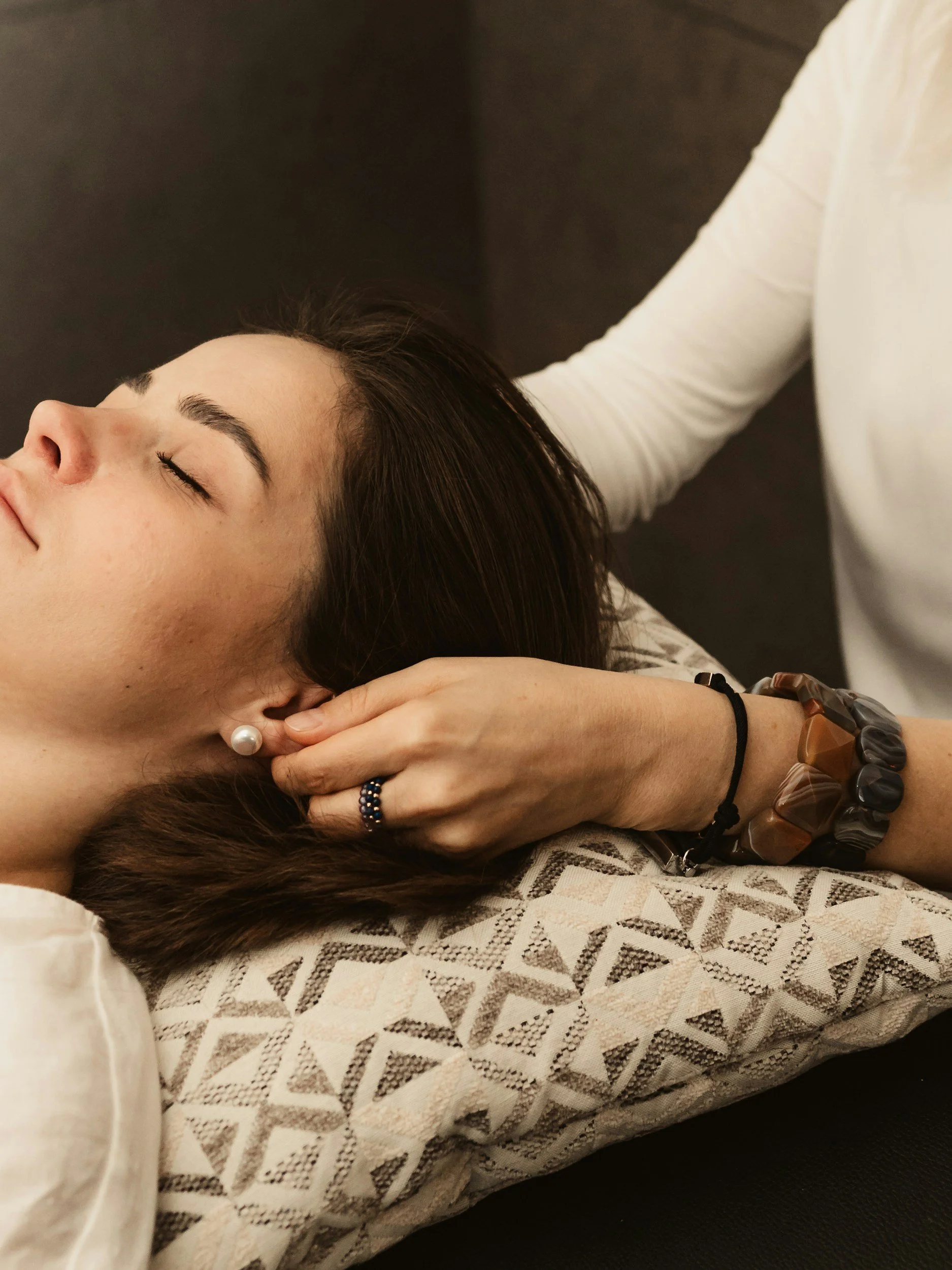 A woman receiving craniosacral therapy.