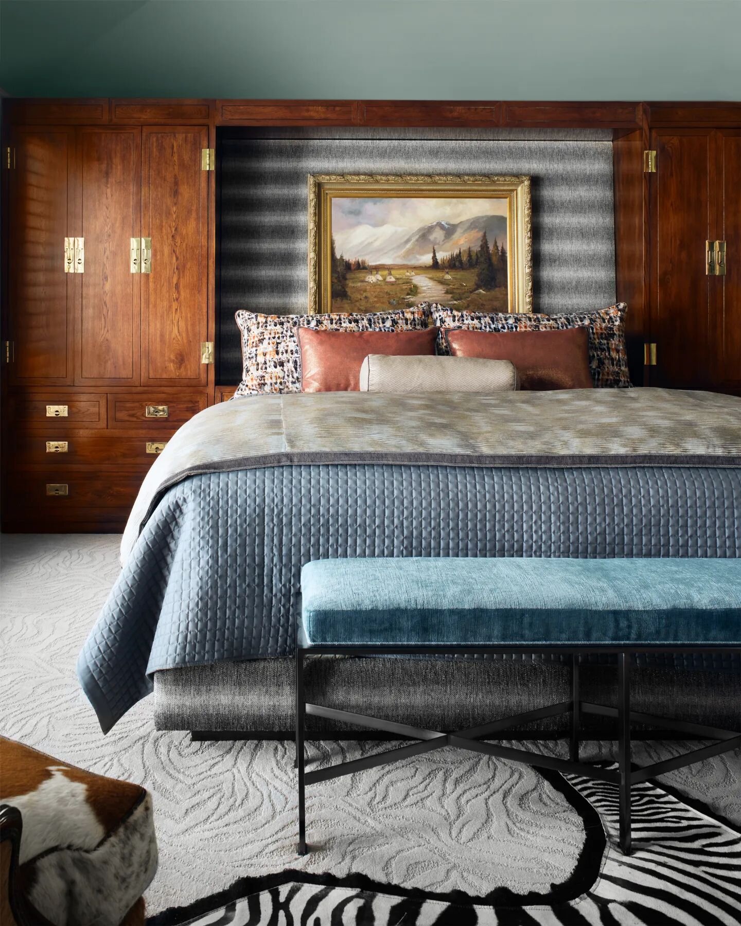 Looking back on this handsome primary bedroom from a recent remodel. Our client's vintage Campaign-style bed unit provides a grounding backdrop that is softened by natural patterns and complementing colors to create a polished and poised setting.