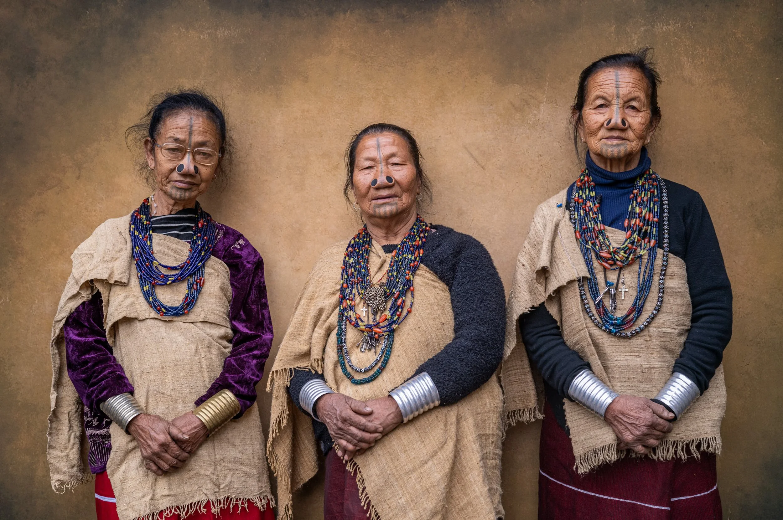 Portrait of three Apatani women in traditional garb