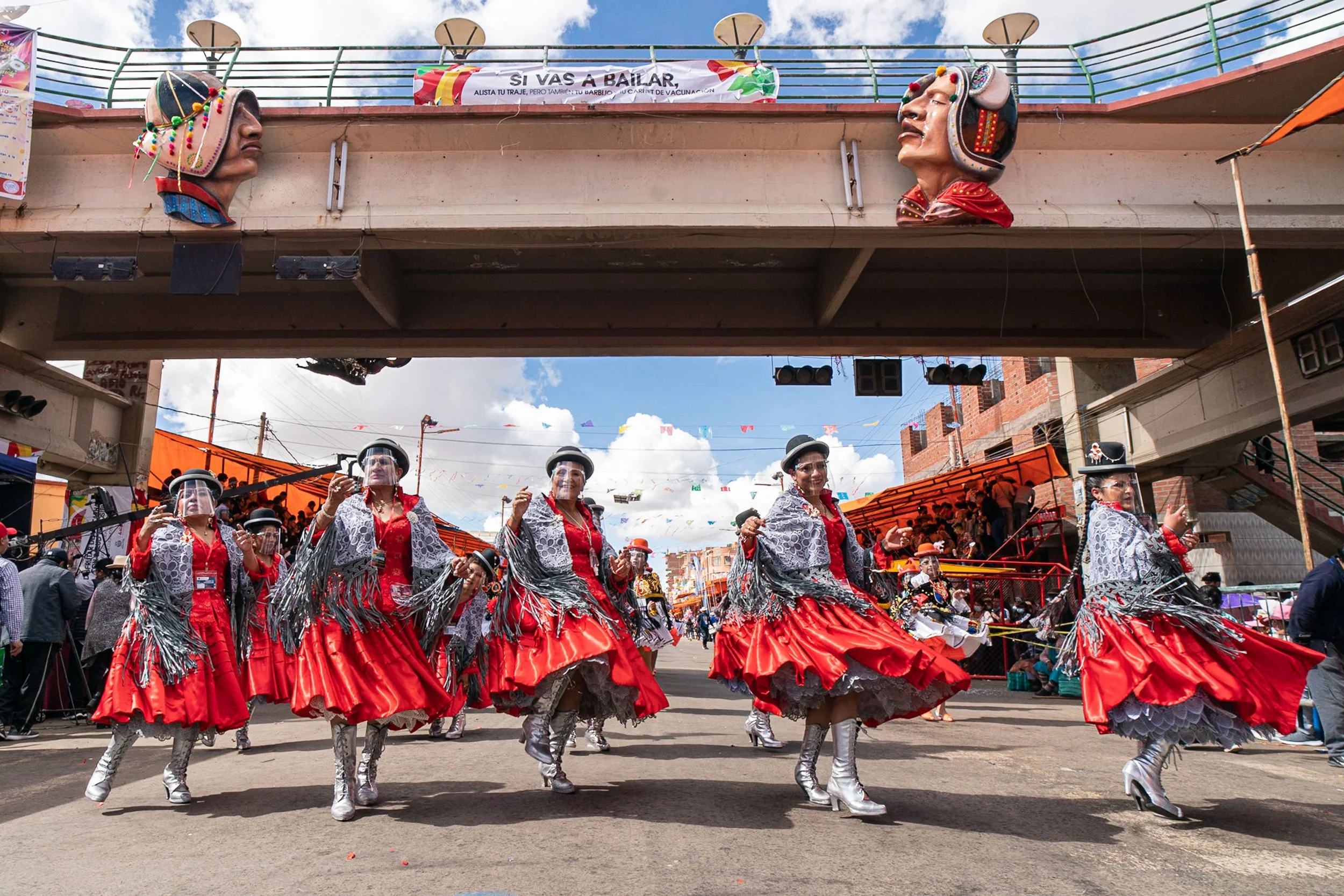 Morenada dancers under bridge in Oruro, Bolivia