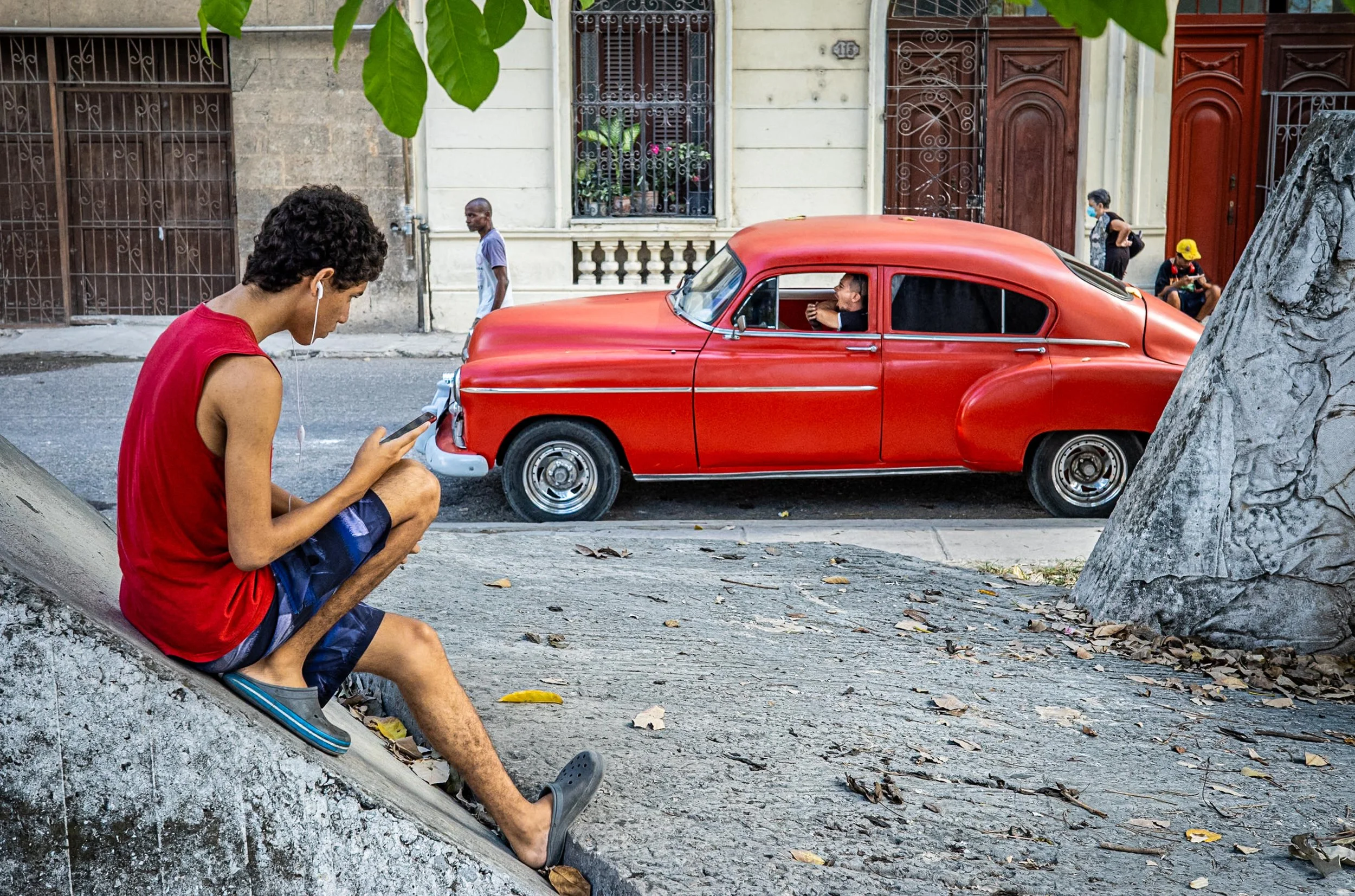 Red classic car and red top boy