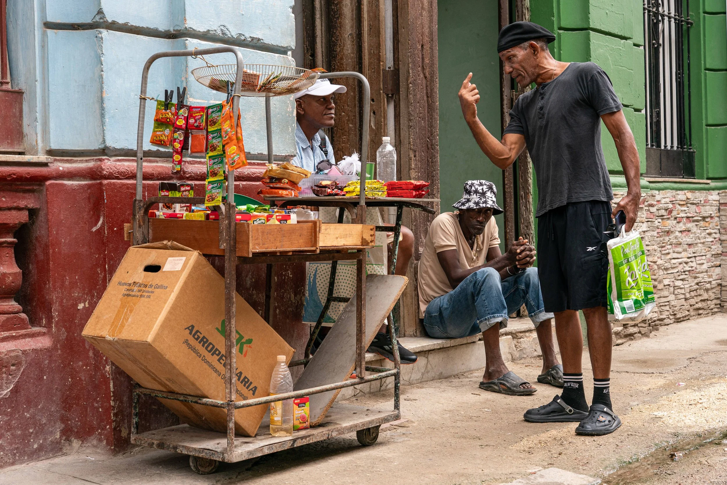 Three men talking on the street in Havana, Cuba