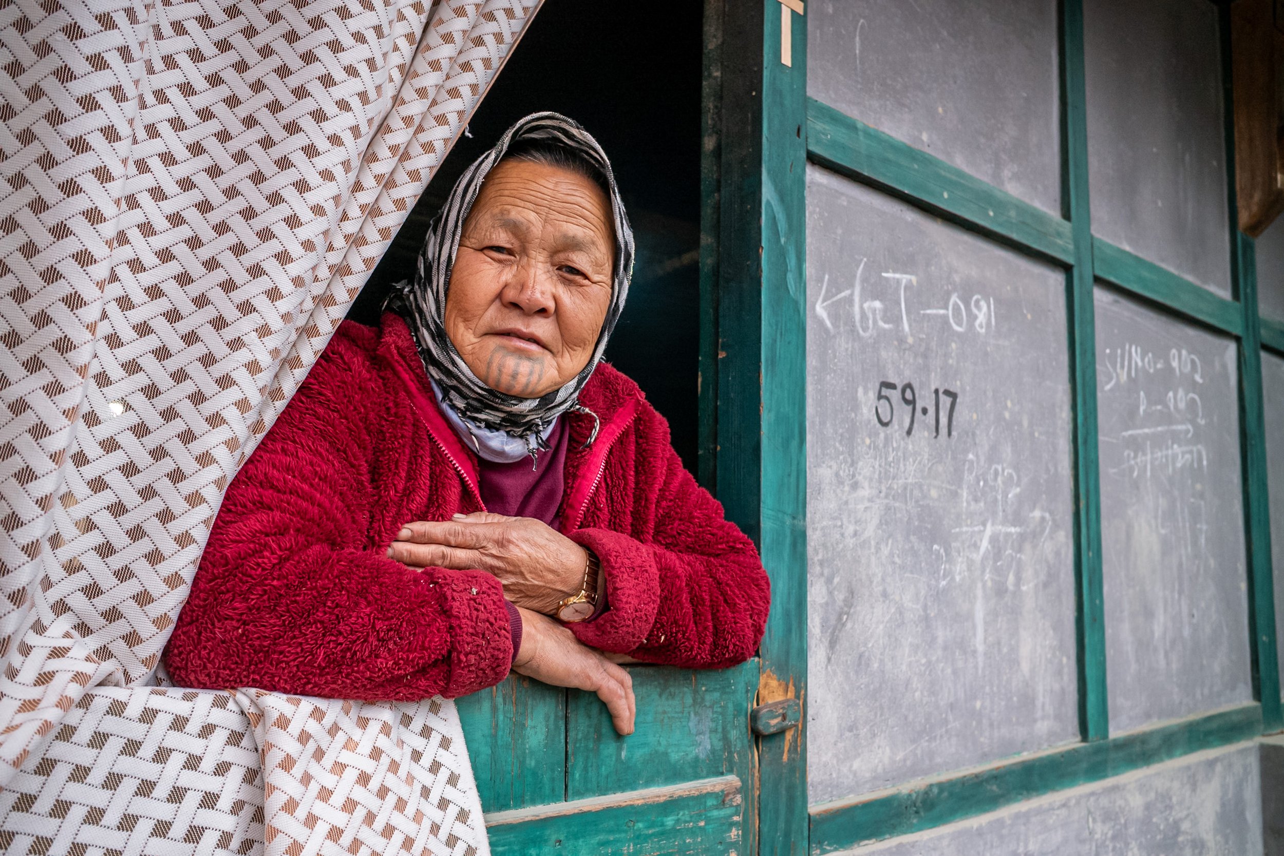 Portrait of Apatani woman in window