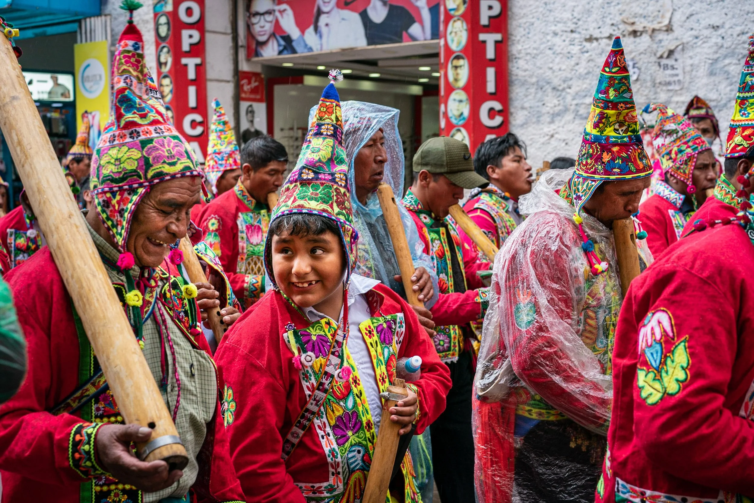 Man and child laughing during the Andean Anata