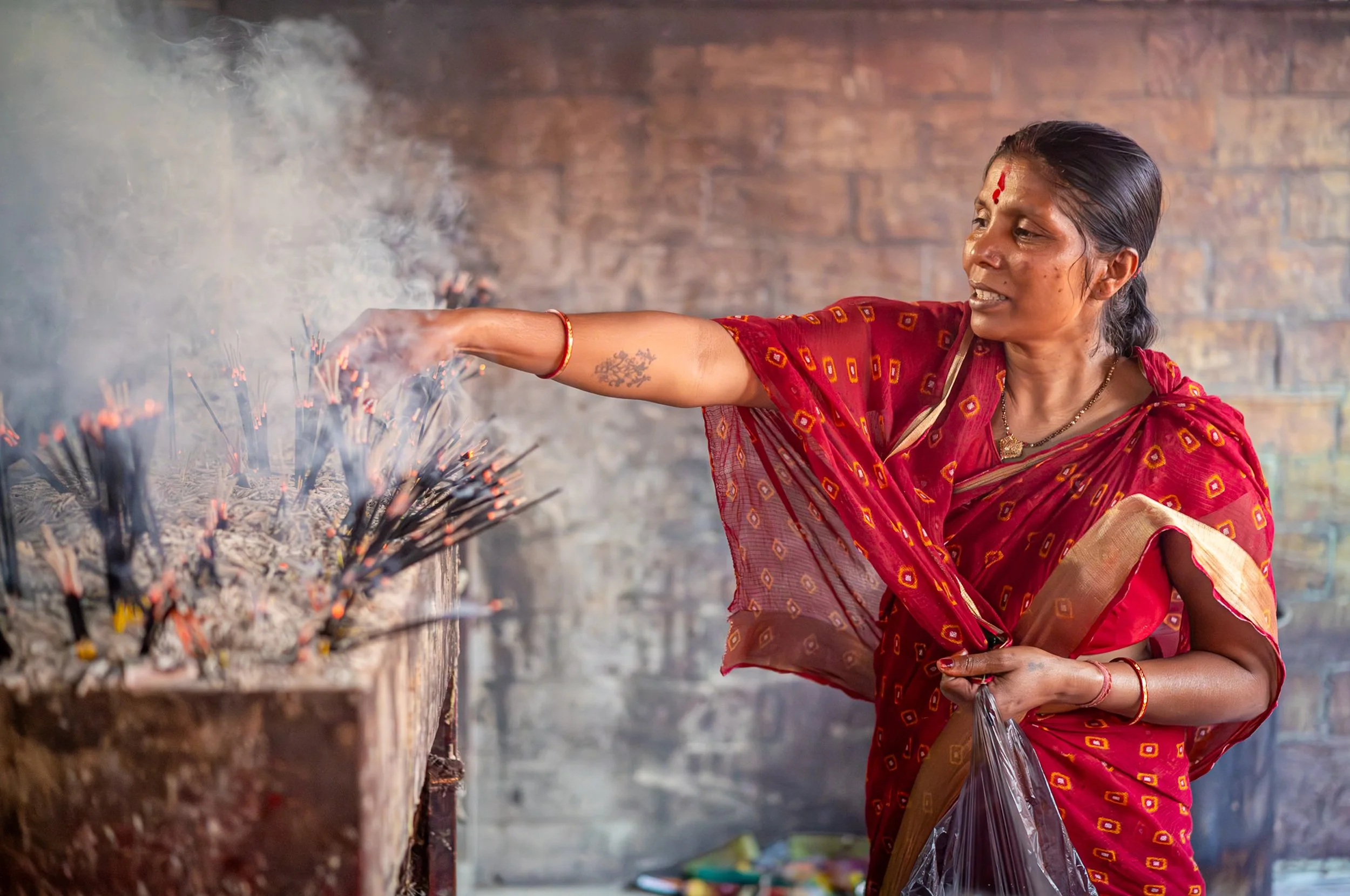 Devotee lighting incense in Guwahati Kamakhaya temple
