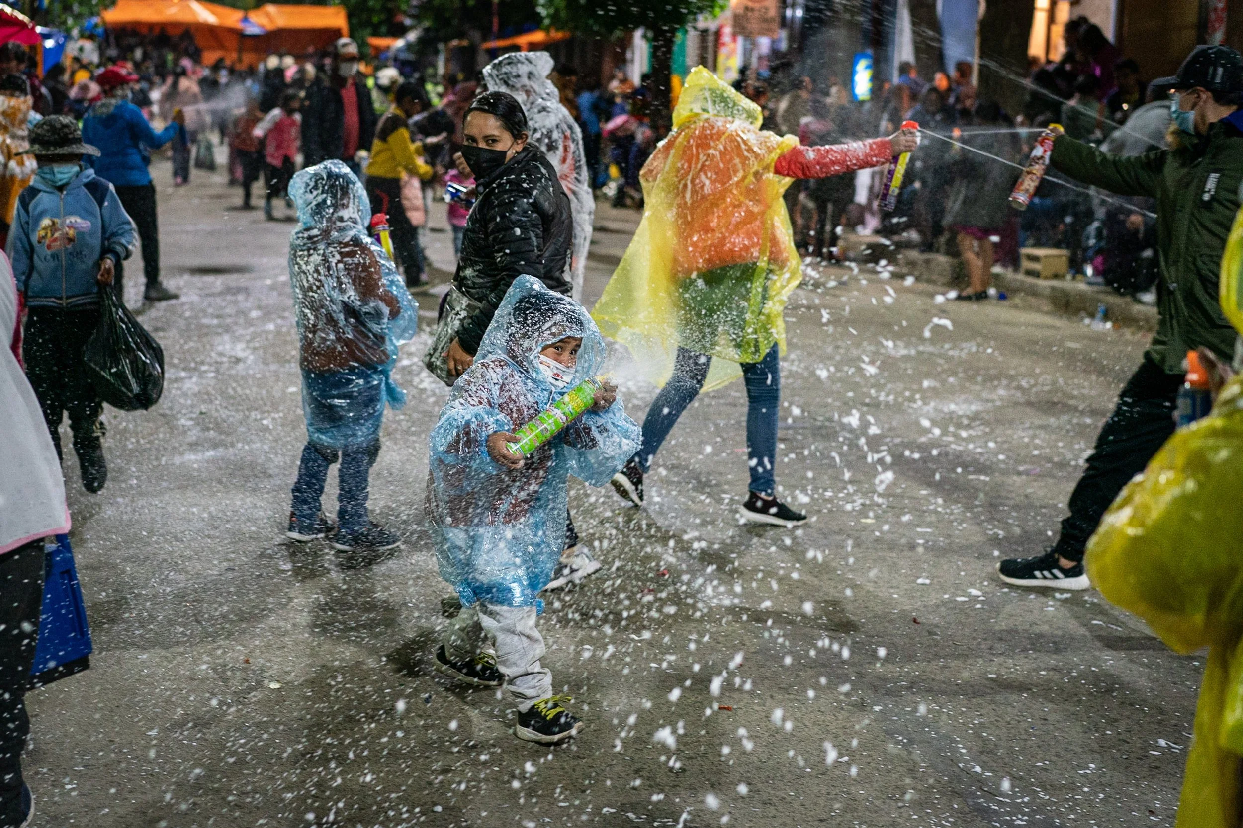 Children playing with foam spray during the Peregrinación