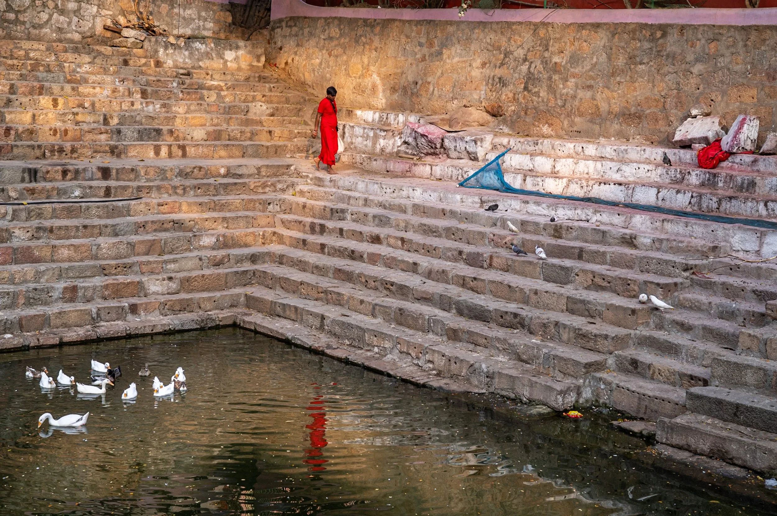 Man in red walking on ghat at Guwahati Kamakhaya temple