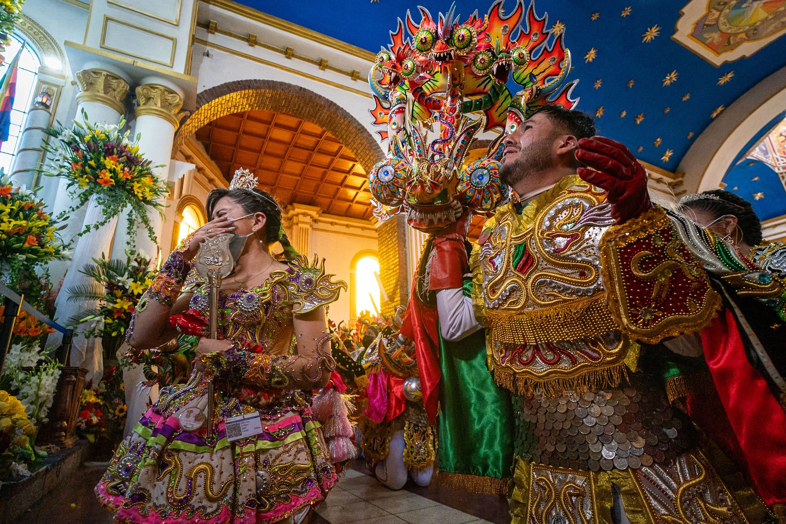 China Supay and Diablo masks kneeling in front of the virgin and crying during the Peregrinación