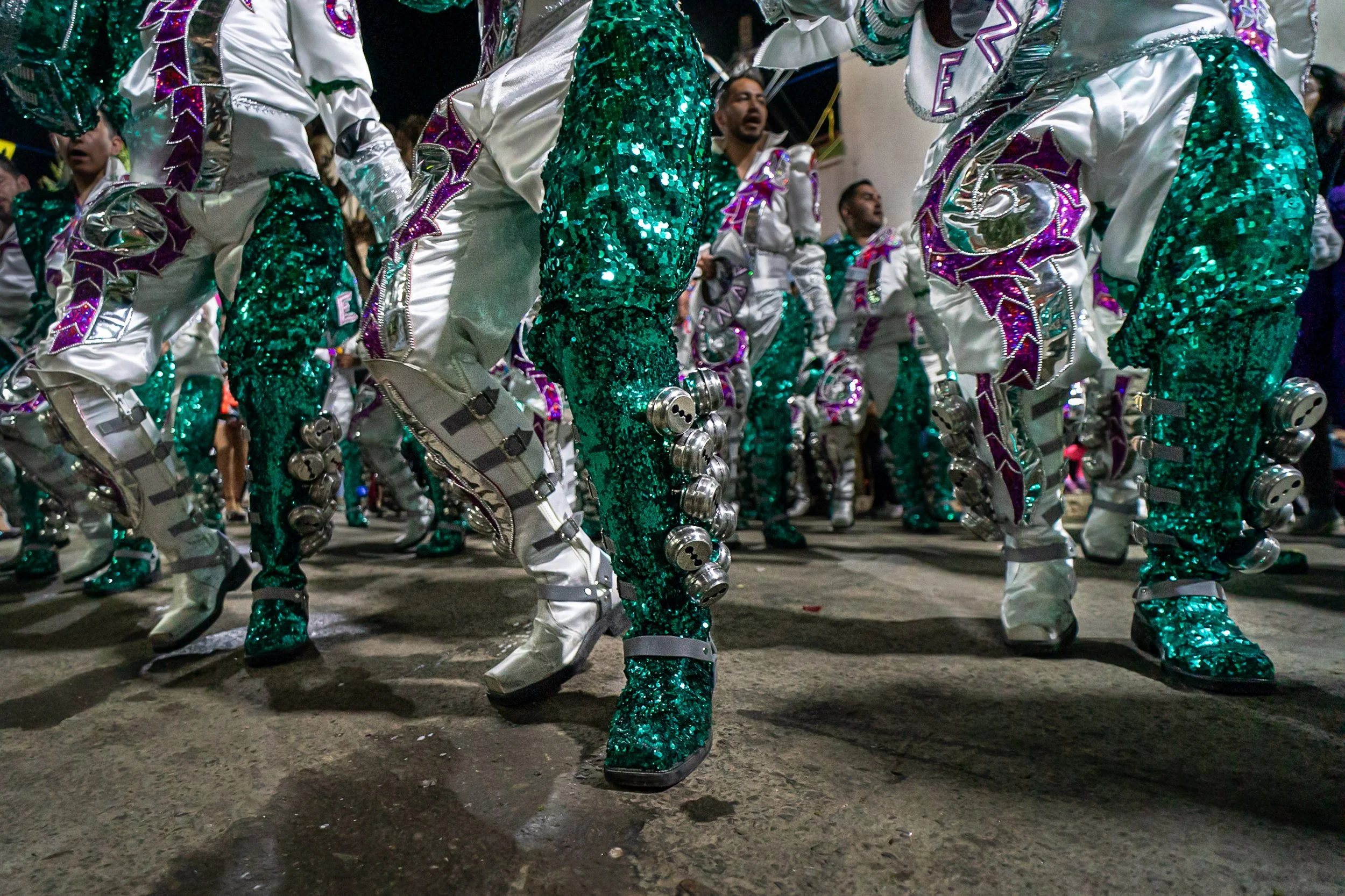 Caporales legs and bells detail during the Peregrinación