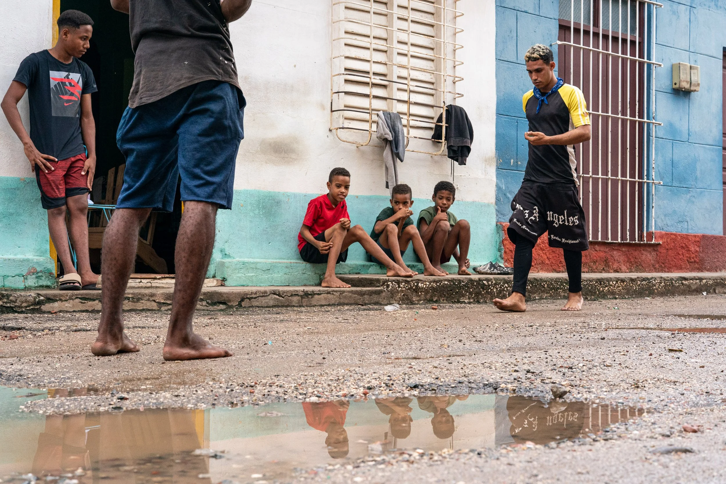 Children reflected in puddle in Trinidad, Cuba