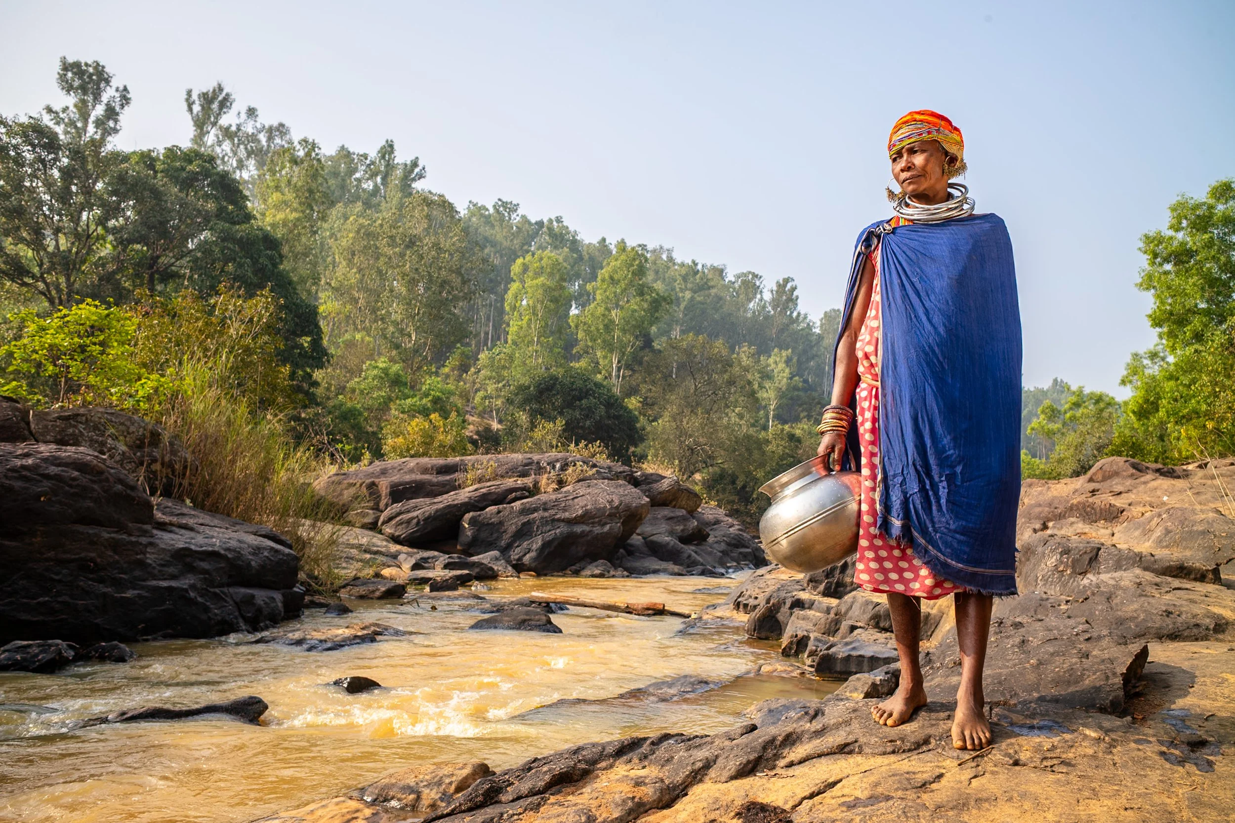 Portrait of woman in traditional garb with pot in Odisha 
