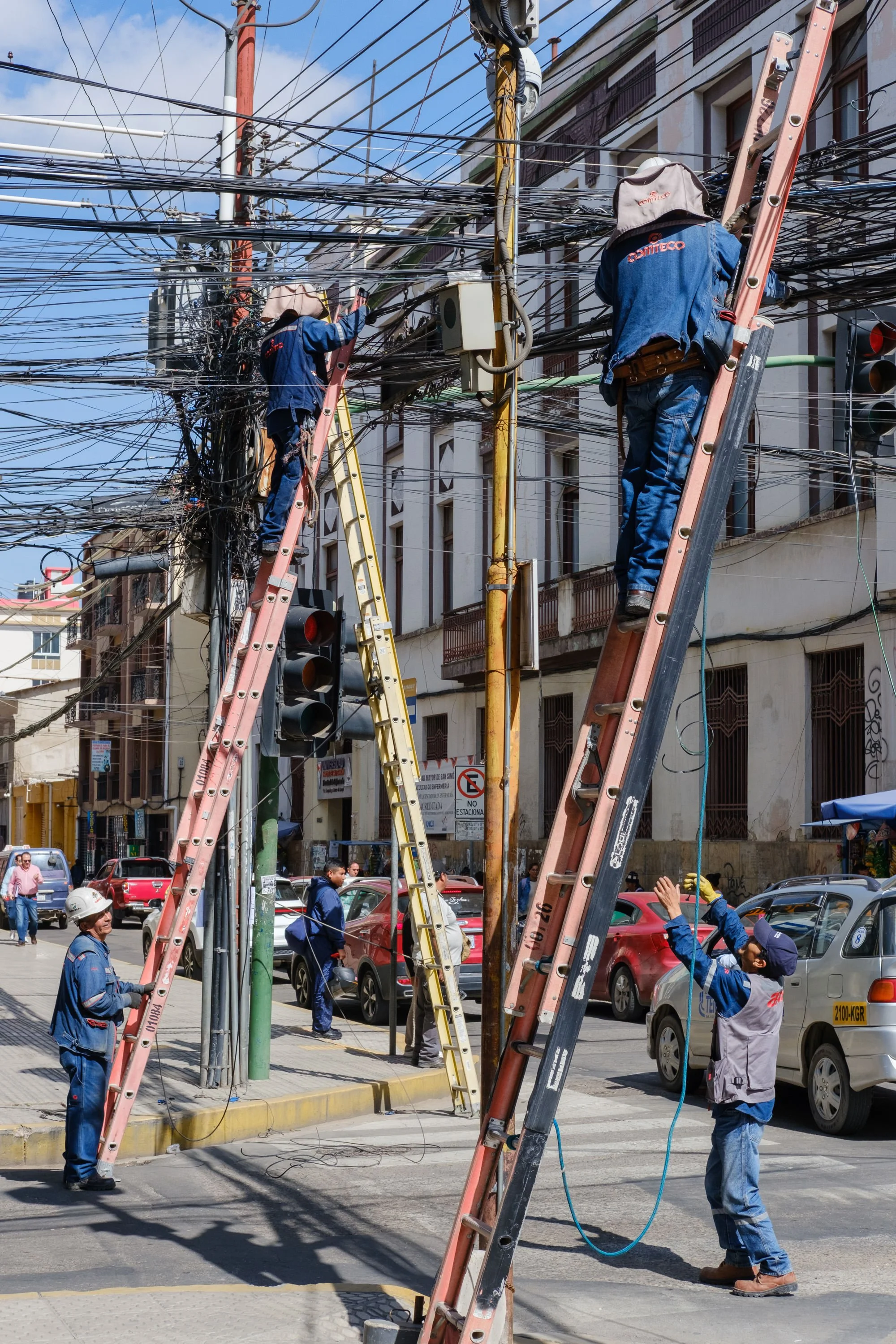 Electricity workers on street on ladders in Cochabamba