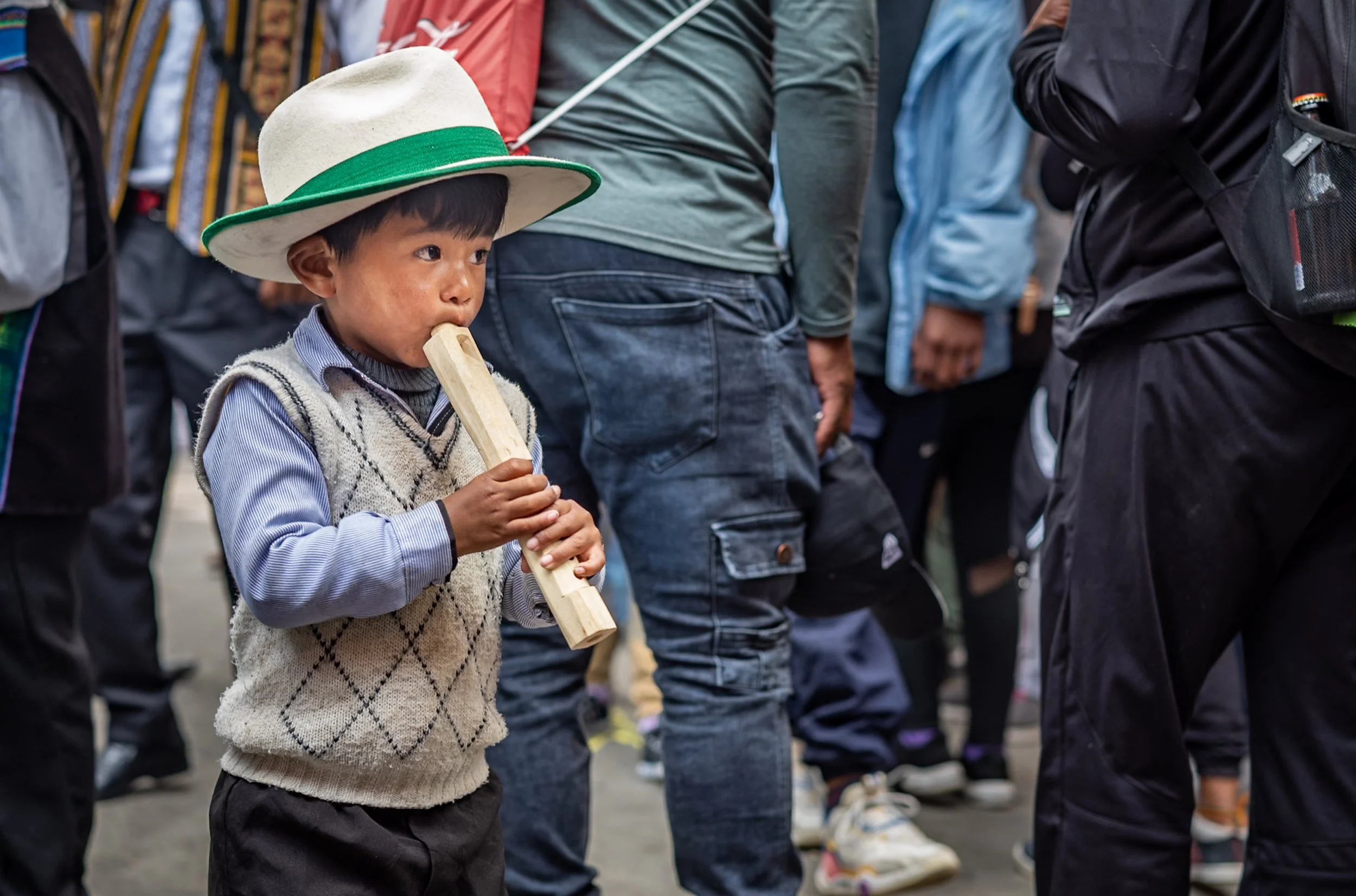 Child playing flute during Andean Anata