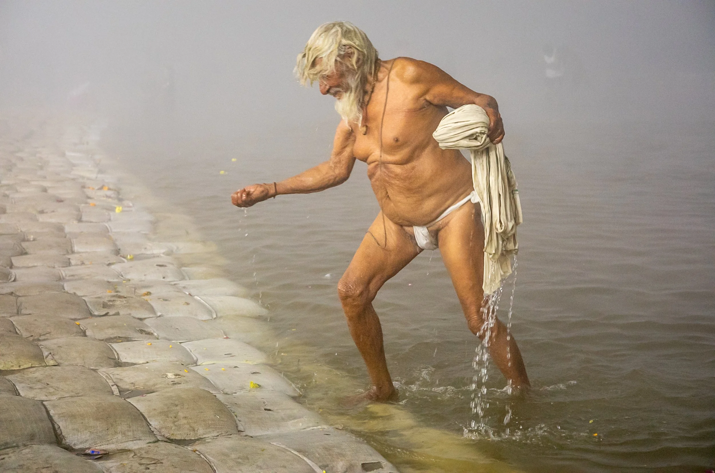 Old man emerging from Ganges in Allahabad
