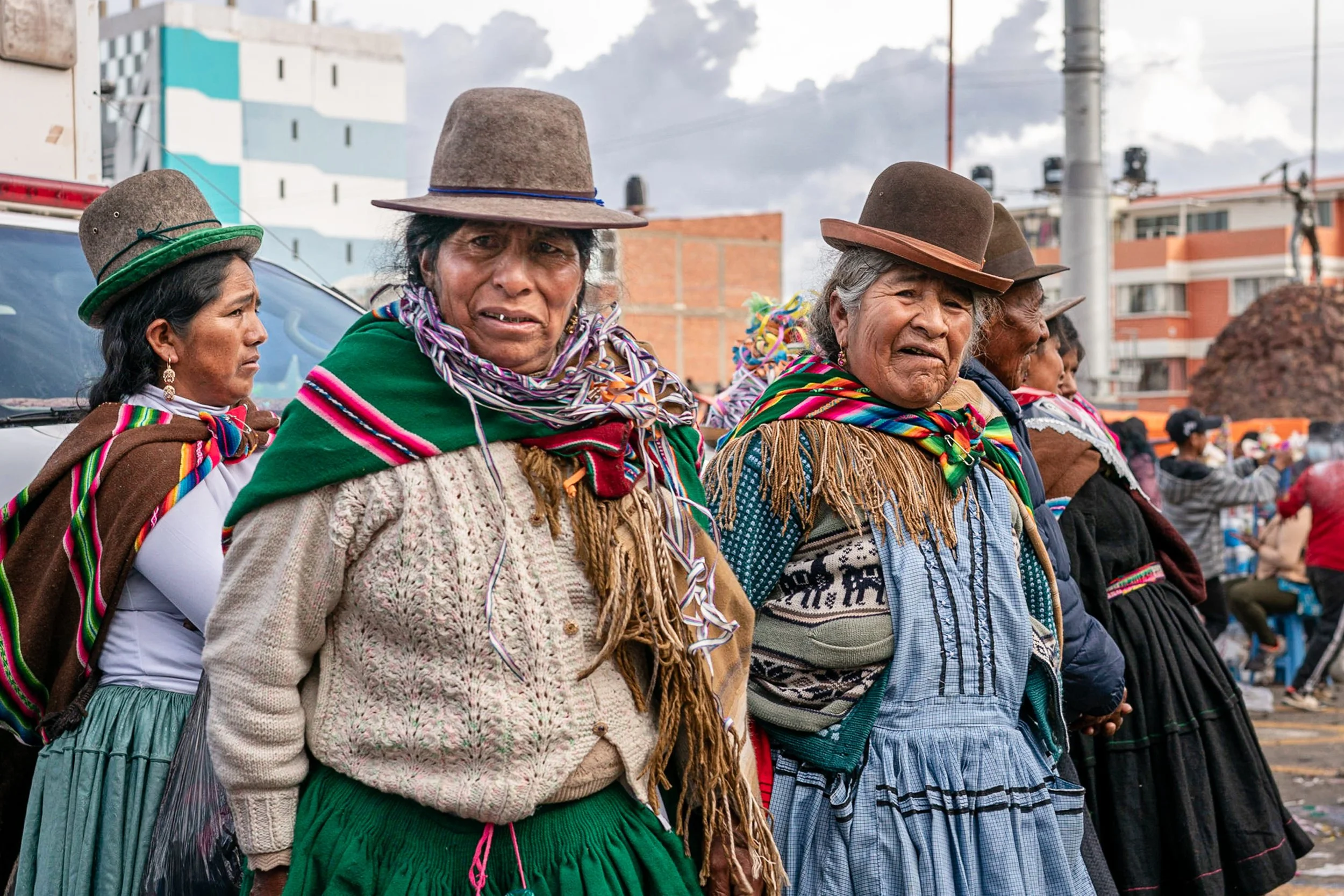 Three cholitas looking around in Oruro, Bolivia