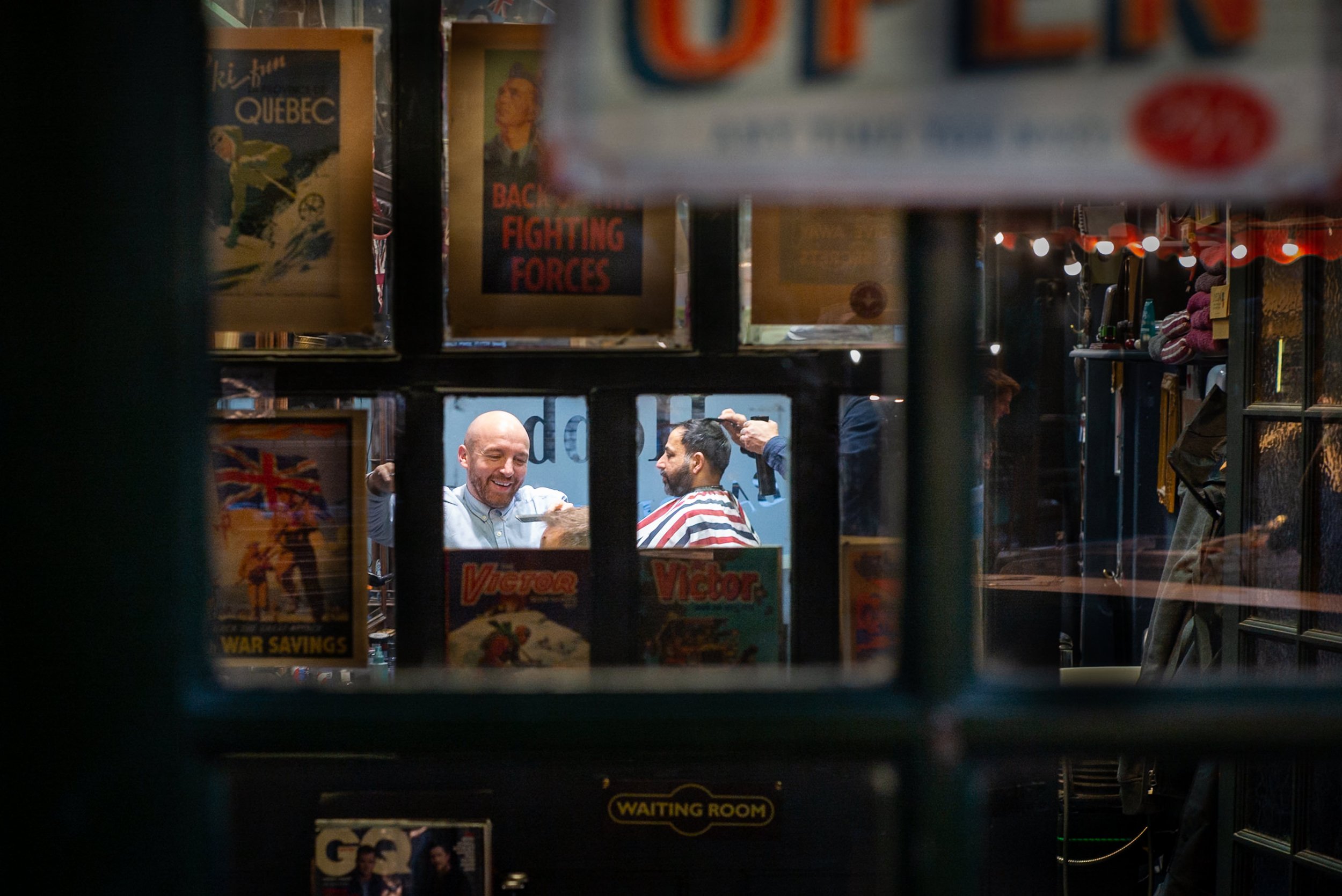 Barber and client framed by several layers of window frames