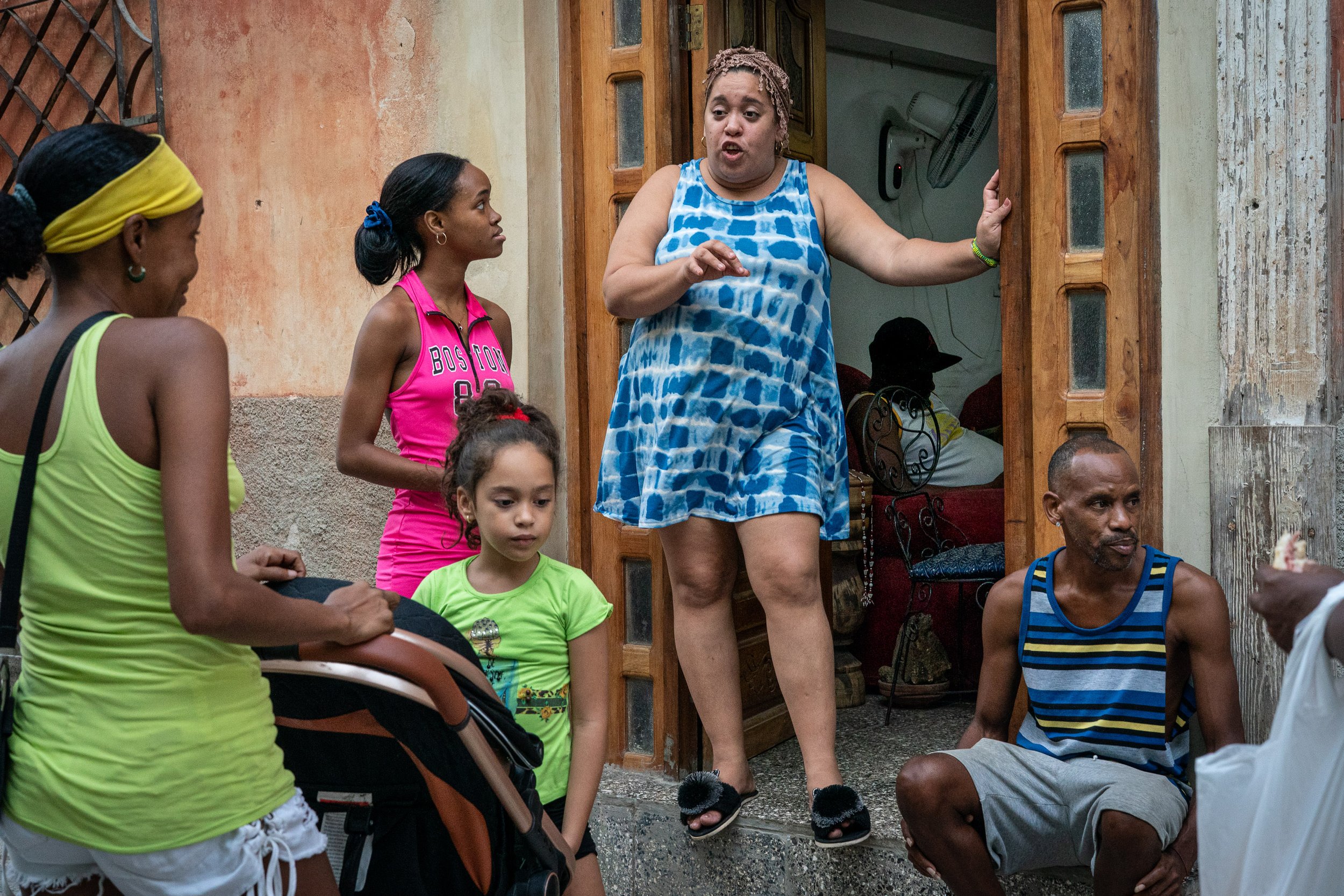 Group talking on froont door in Havana, Cuba