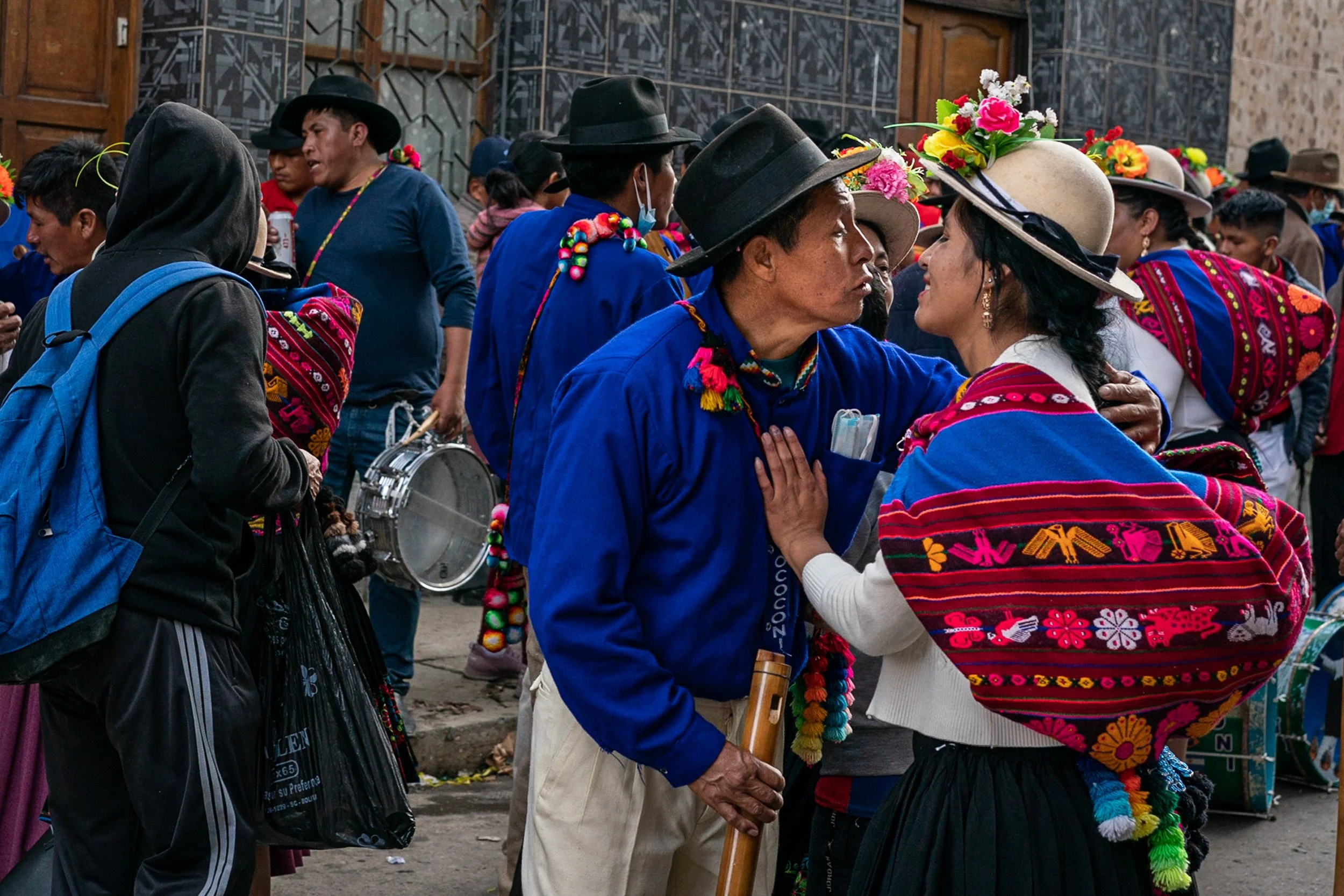 Man trying to kiss demurring woman during Andean Anata 