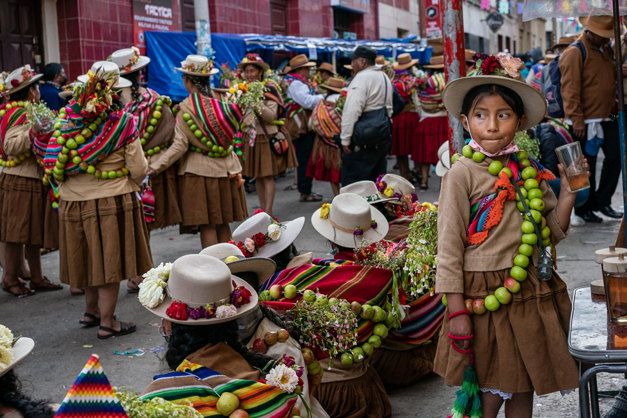 Child with refreshment during Andean Anata 