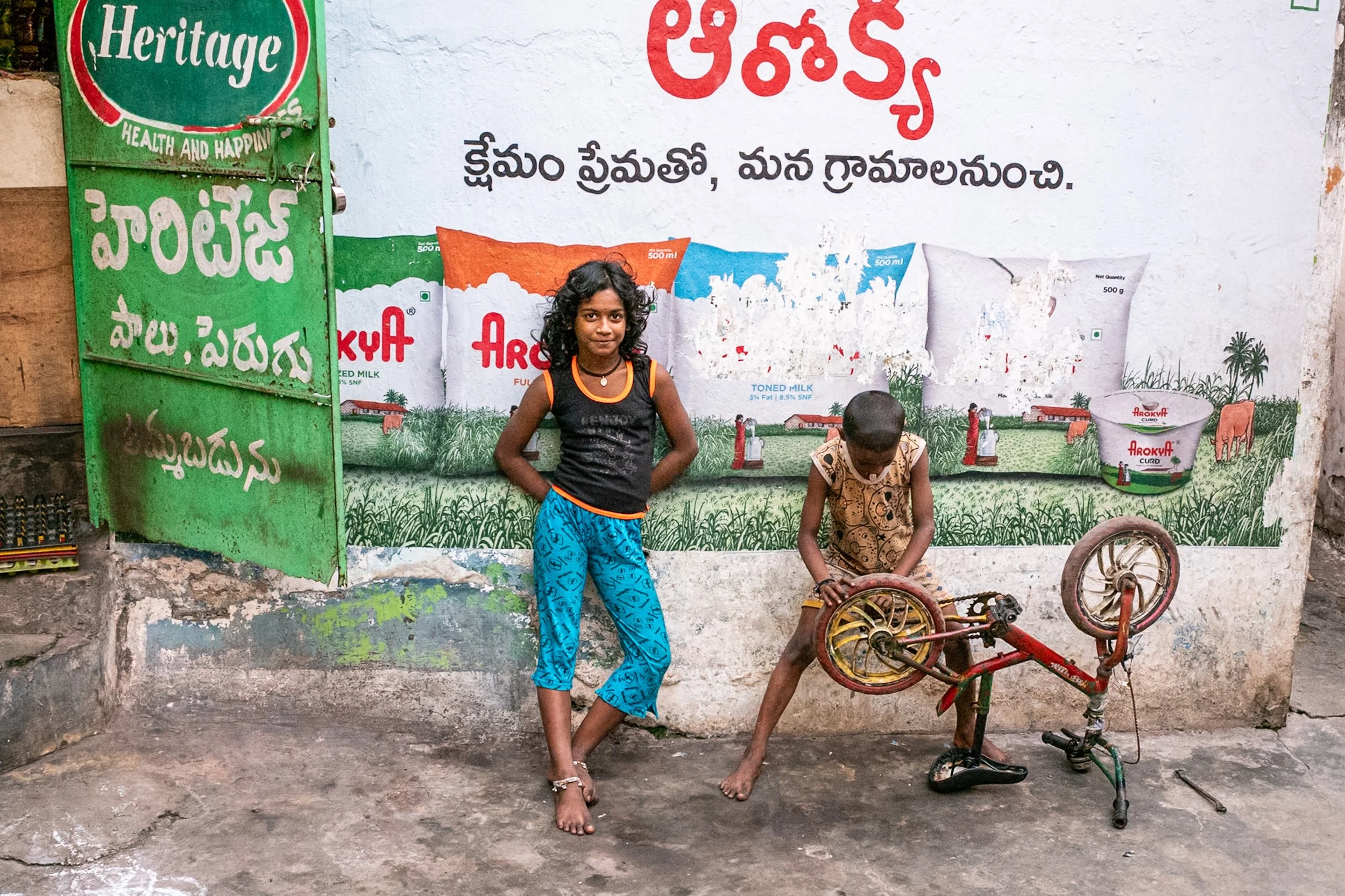 Portrait of girl and boy repairing bike in Visakhapatnam