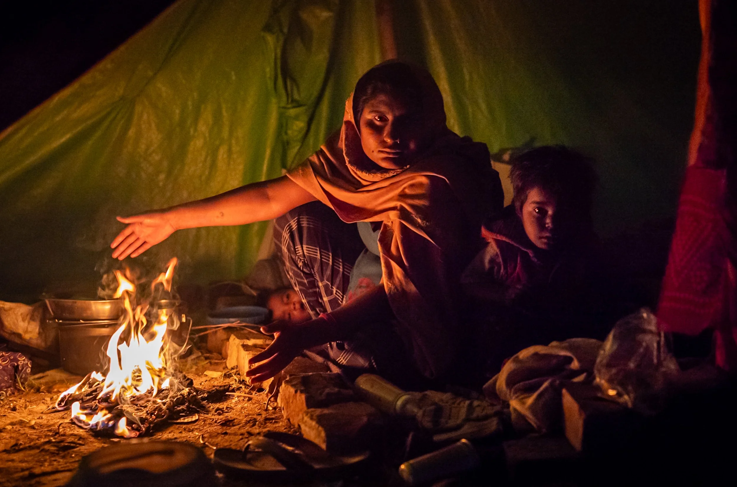 Woman and children warming with fire in Allahabad