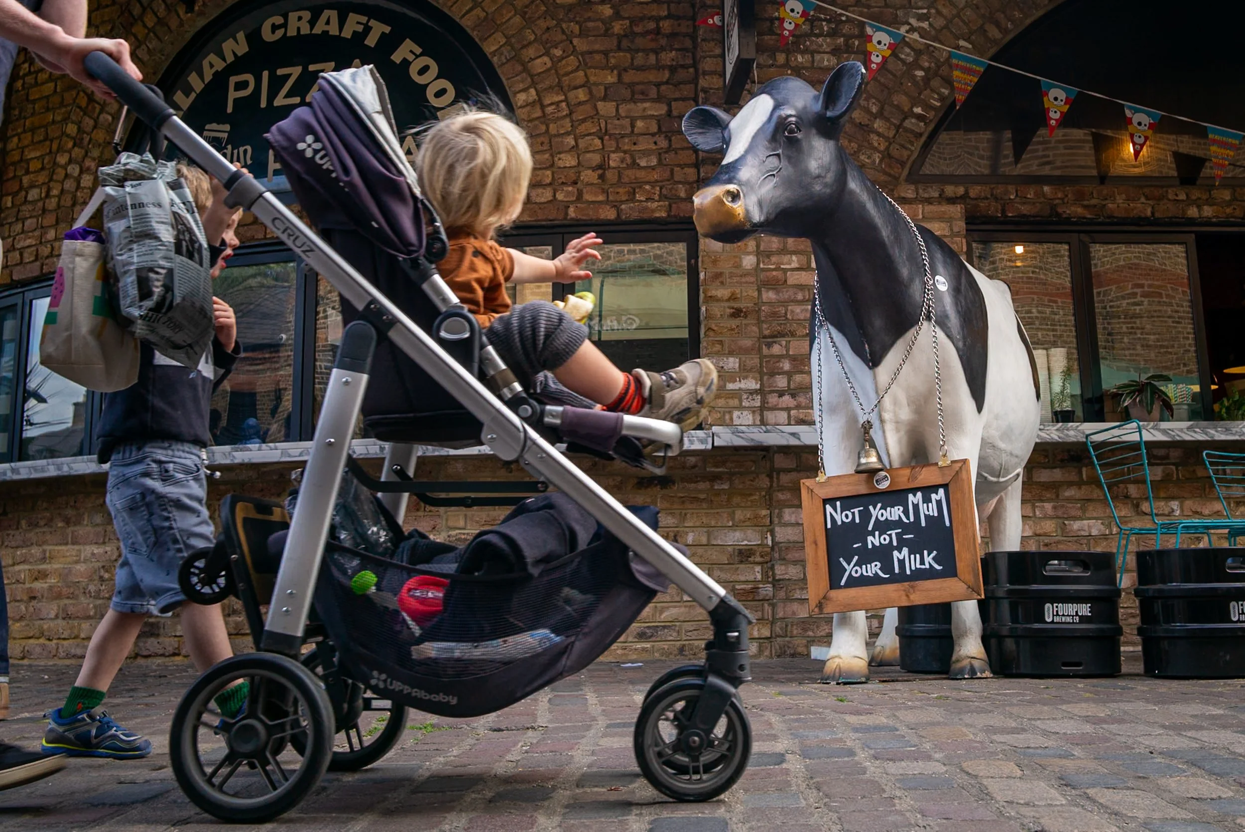 Child looking at cow model saying "not your mom, not your milk"