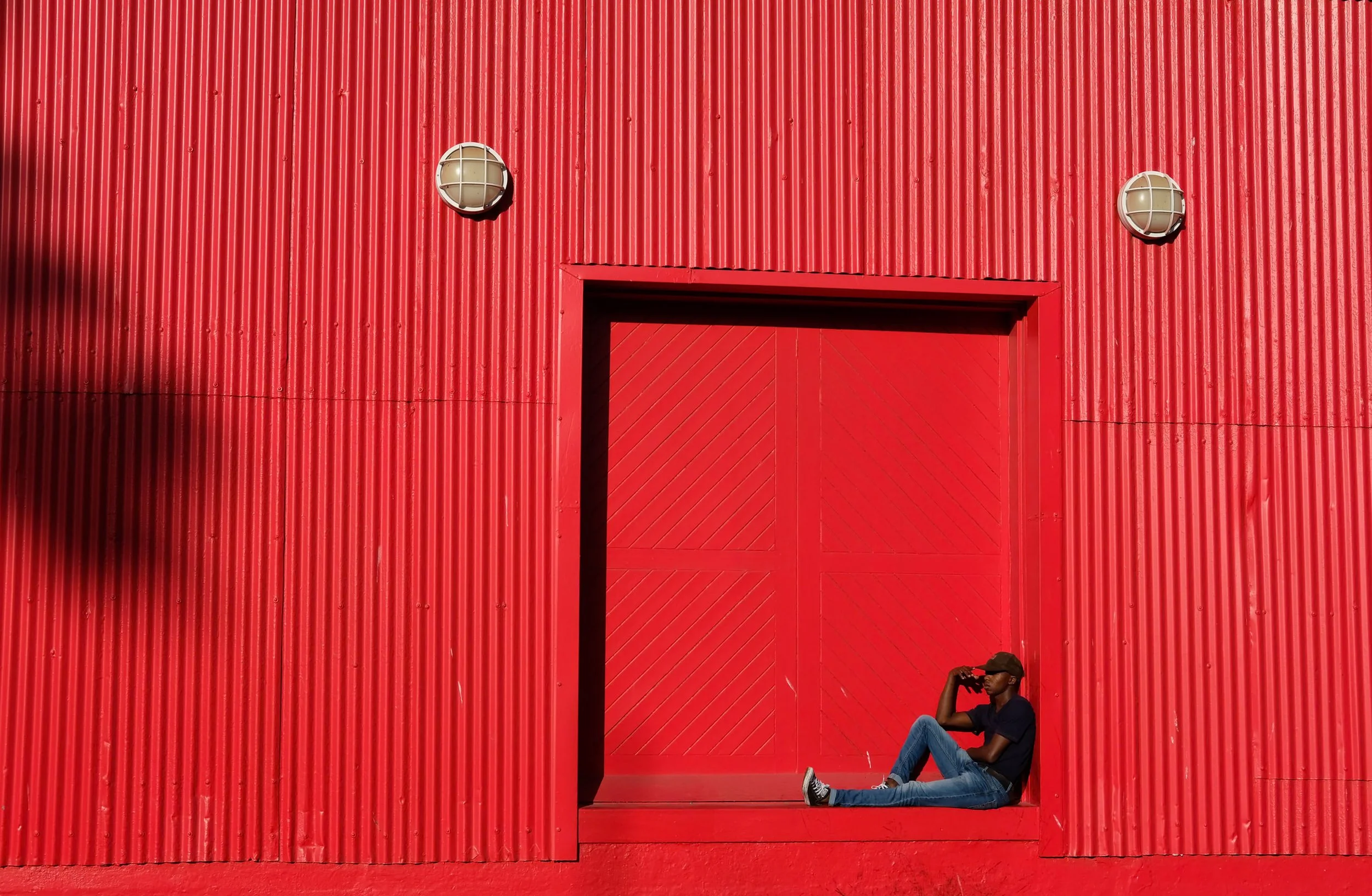Man lounging in red background