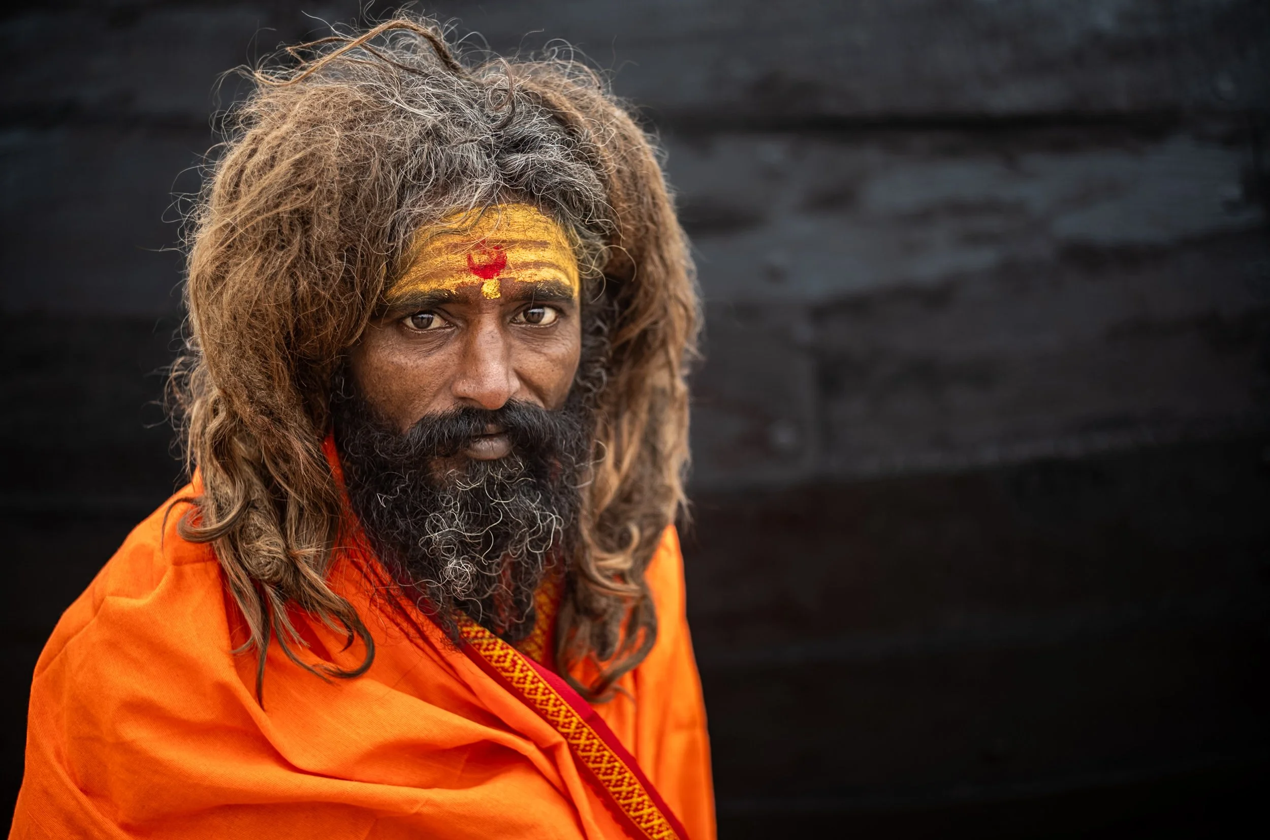 Portrait of Sadhu on black background in Varanasi
