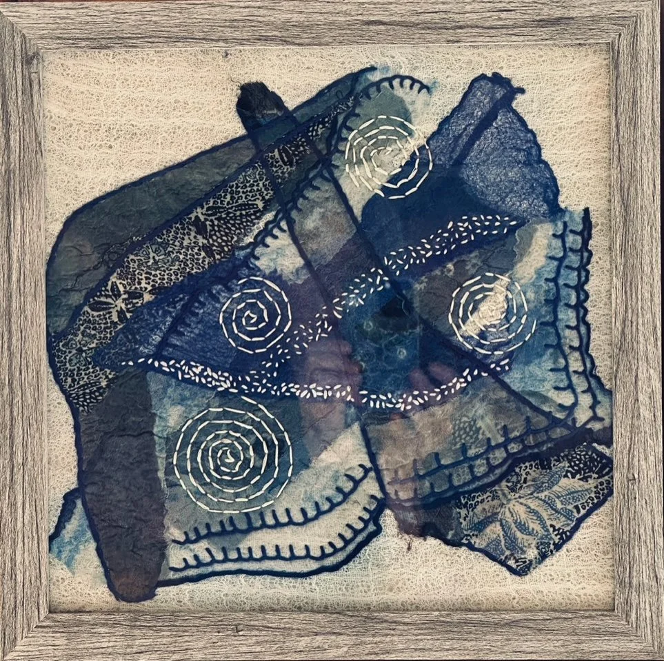 Framed abstract surface design piece made with silk remnants sourced from charity shops and nuno felted on a cheese cloth& wool roving canvas embellished with stitching.