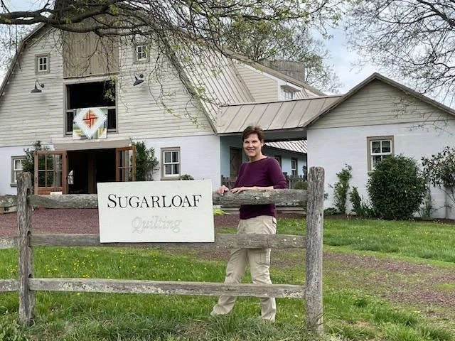 Becky w Sign at Barn.jpg