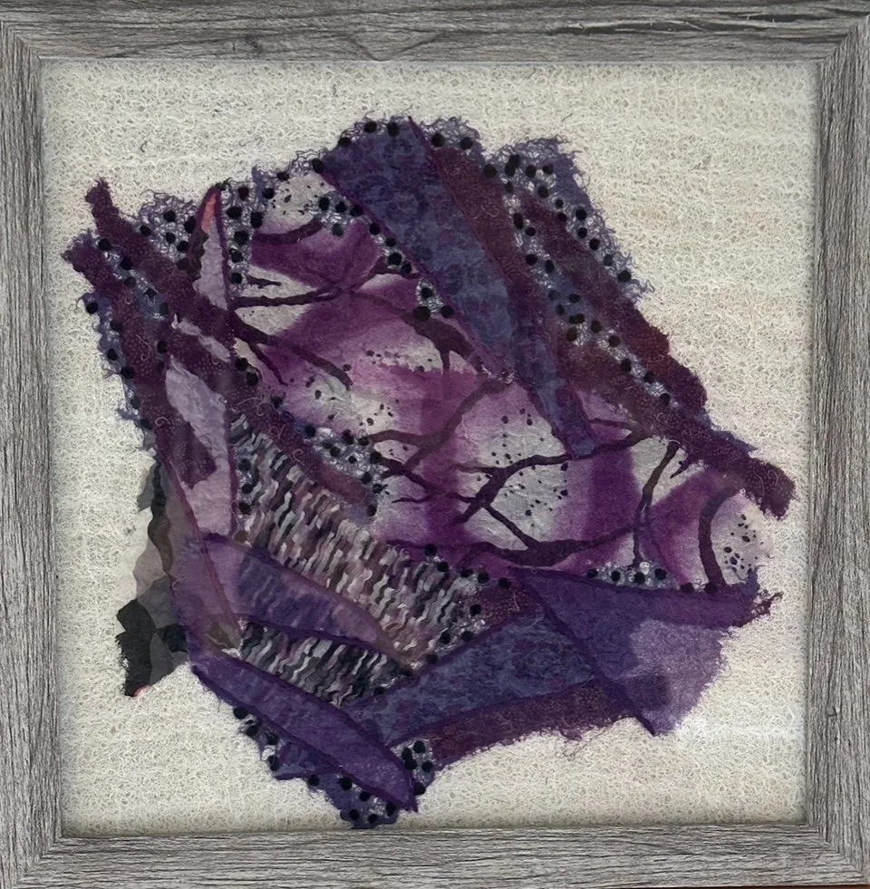 Framed abstract surface design piece made with silk remnants sourced from charity shops and nuno felted on a cheese cloth& wool roving canvas embellished with stitching.