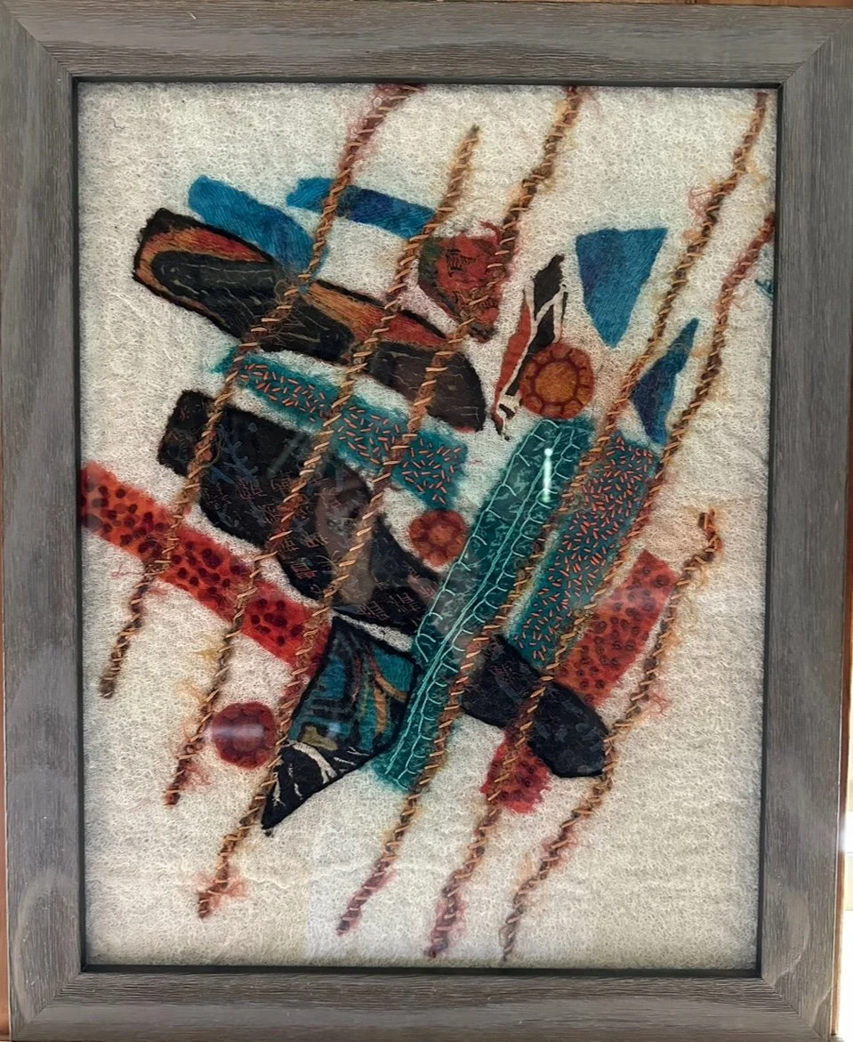 Framed abstract surface design piece made with silk remnants sourced from charity shops and nuno felted on a cheese cloth& wool roving canvas embellished with stitching.