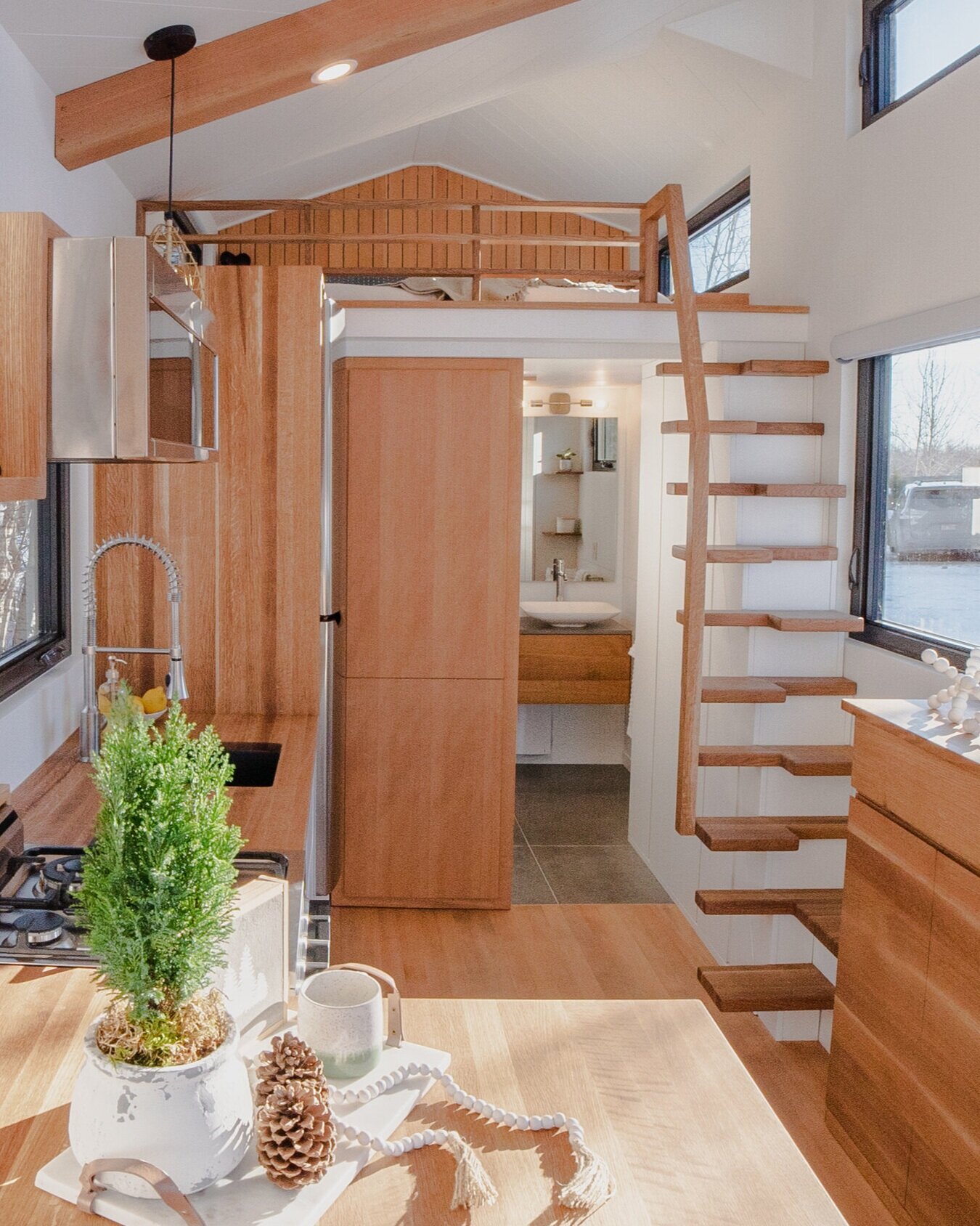 Tiny house boosts living space with motorized deck and spiral staircase