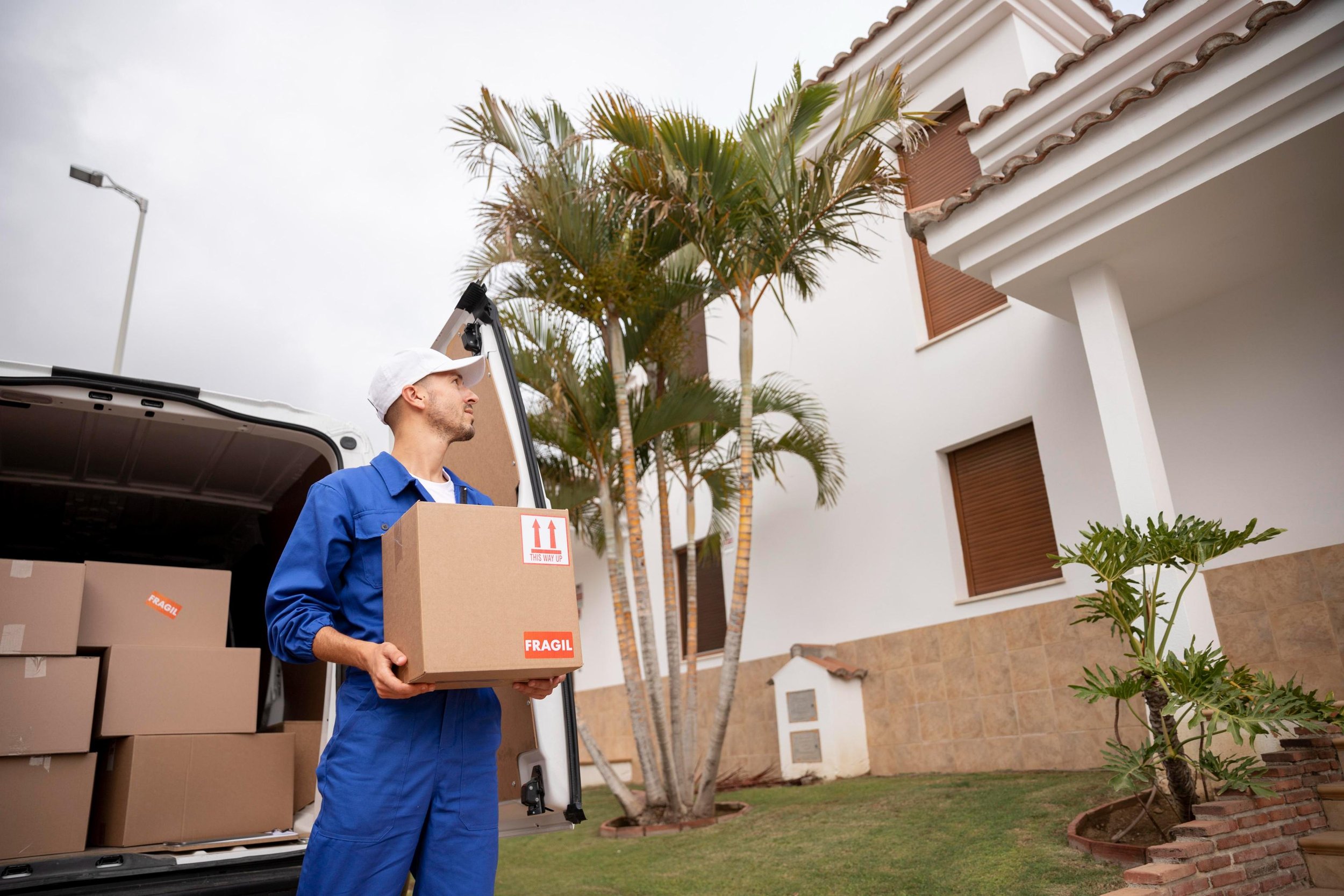 medium-shot-delivery-man-holding-box.jpg