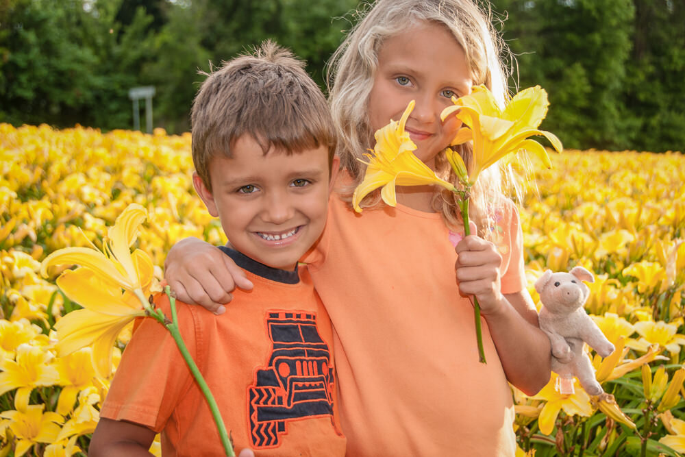brother and sister in a patch of daylilies