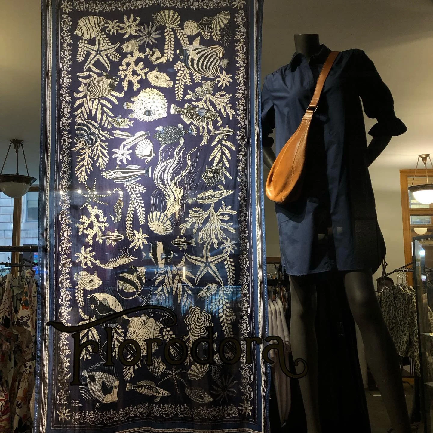 A pop of blue in our window. Come swim by the store this week!