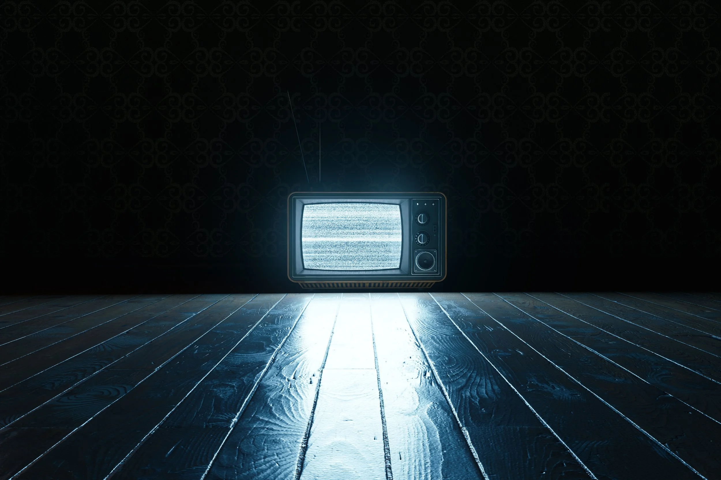 TV showing static in a dark empty room